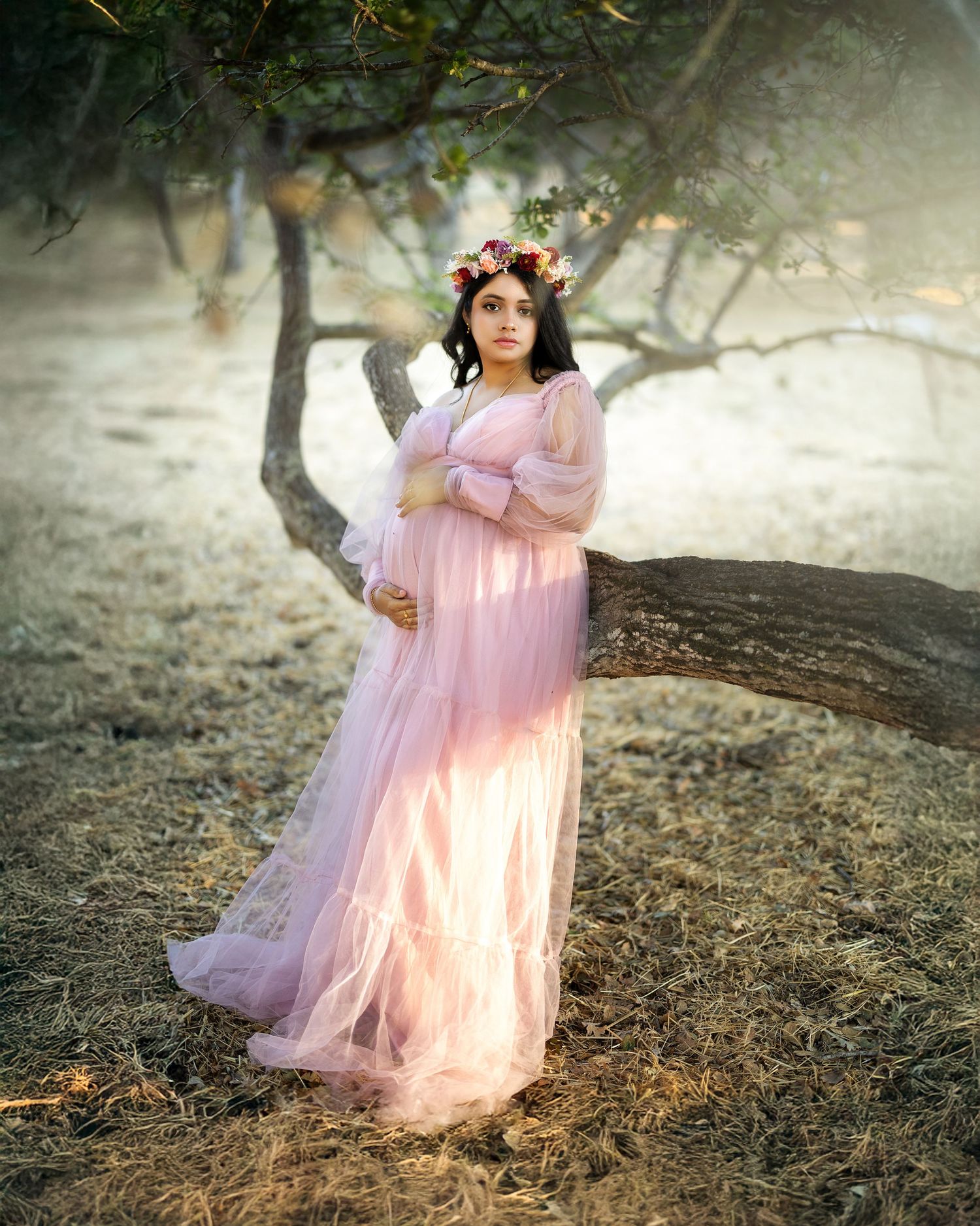 A figure in a flowing pink dress twirls gracefully among misty trees in an ethereal outdoor setting.