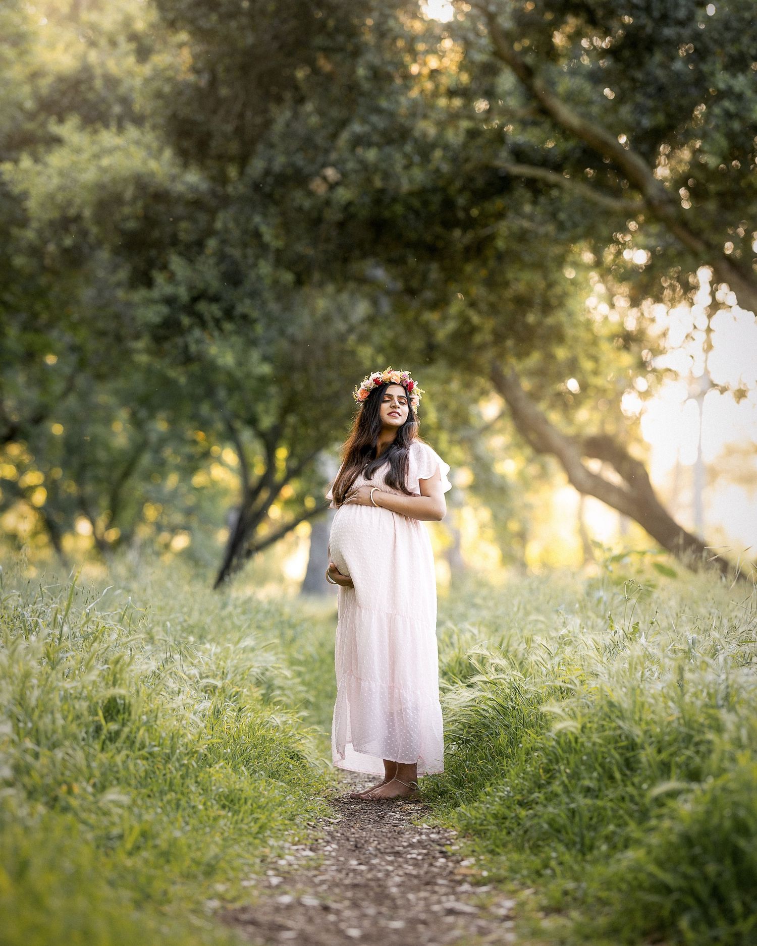 A series of dreamy outdoor photos showing a person in a white dress walking through a sunlit meadow with trees at sunset.