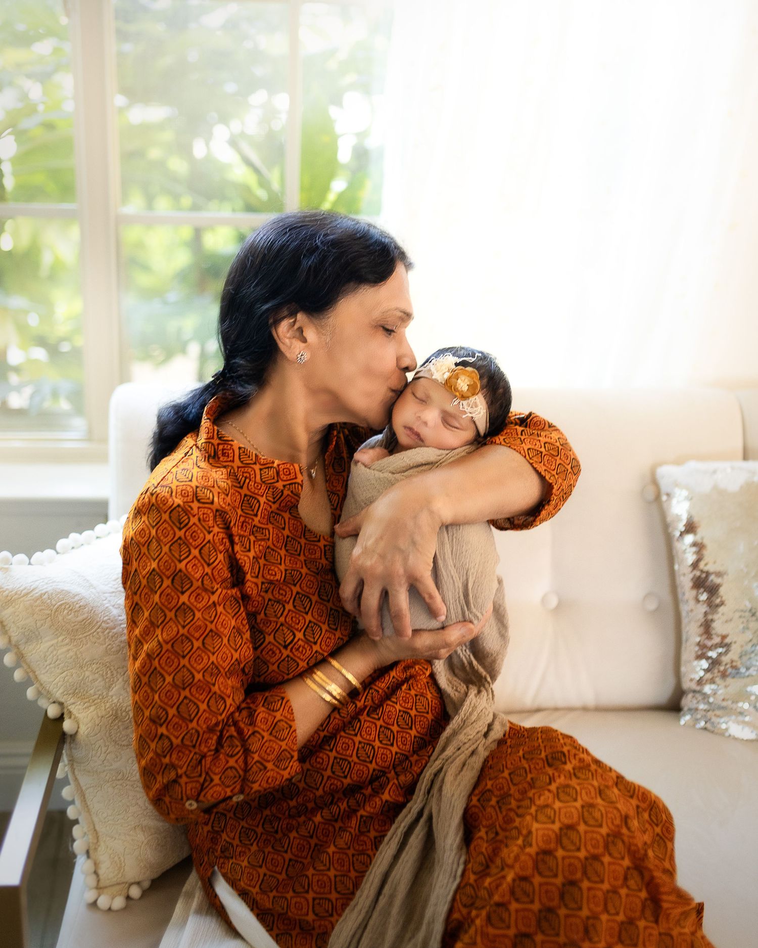 A tender moment of affection and comfort shared between two people wearing orange patterned clothing.