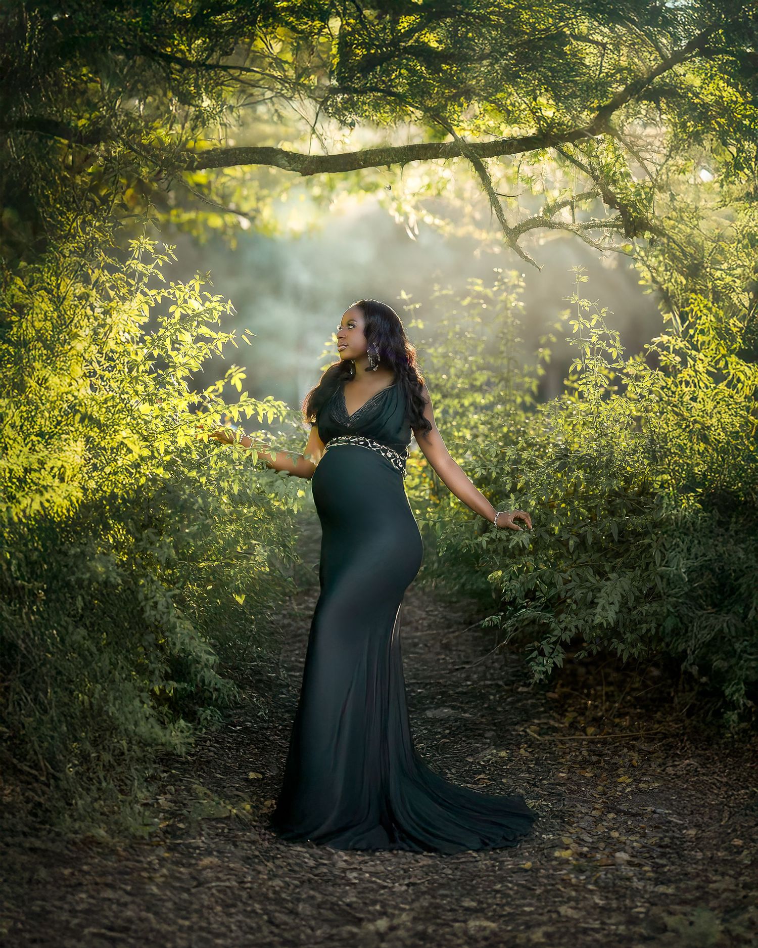 A figure in a flowing dark dress dances gracefully among sunlit trees in a mystical forest setting.