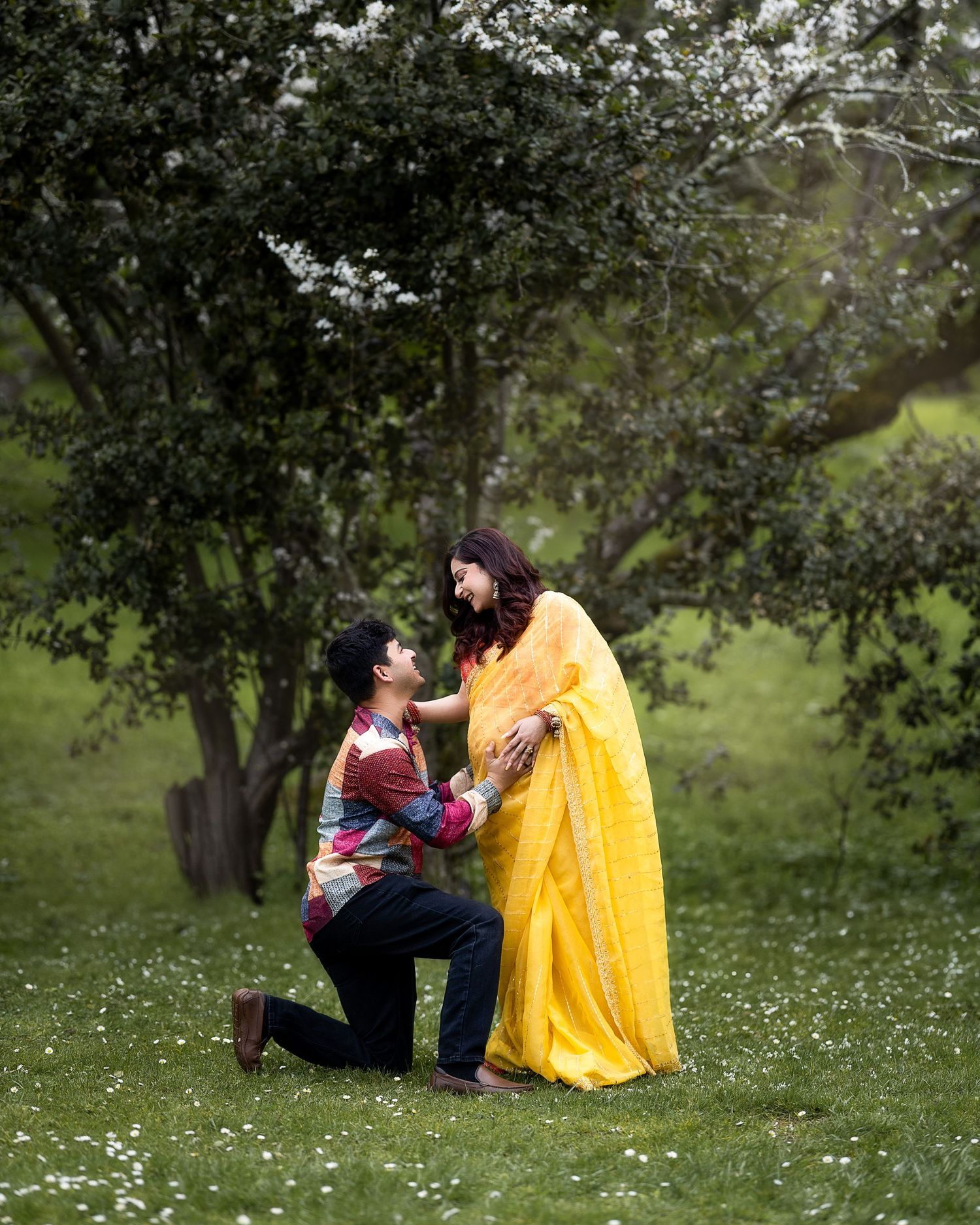 A romantic outdoor scene with a yellow dress against a backdrop of trees and wildflowers.