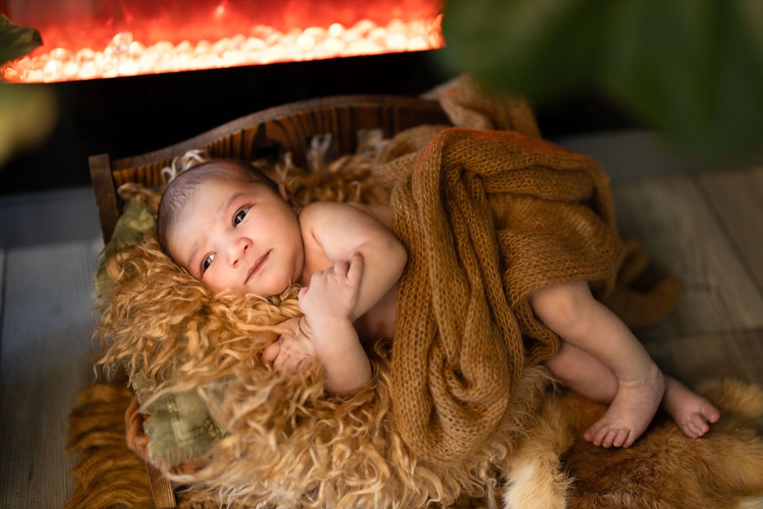 A person with long blonde curly hair lies on a wooden floor in dramatic lighting.
