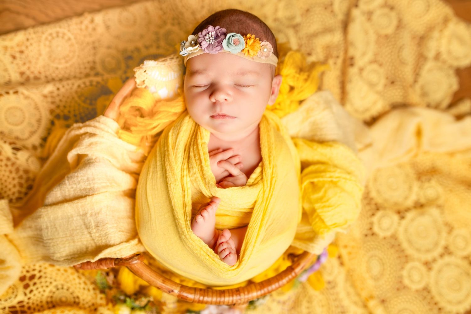 Dreamy yellow fabric arrangement with intricate lace details in warm lighting.