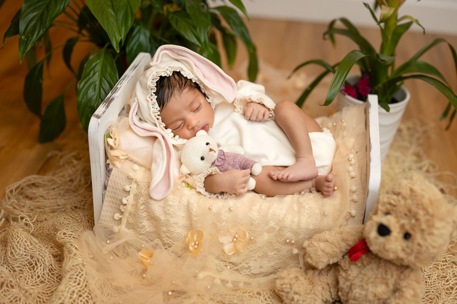 A series of dreamy newborn baby portraits with soft lighting and delicate props in a cream-colored studio setting.