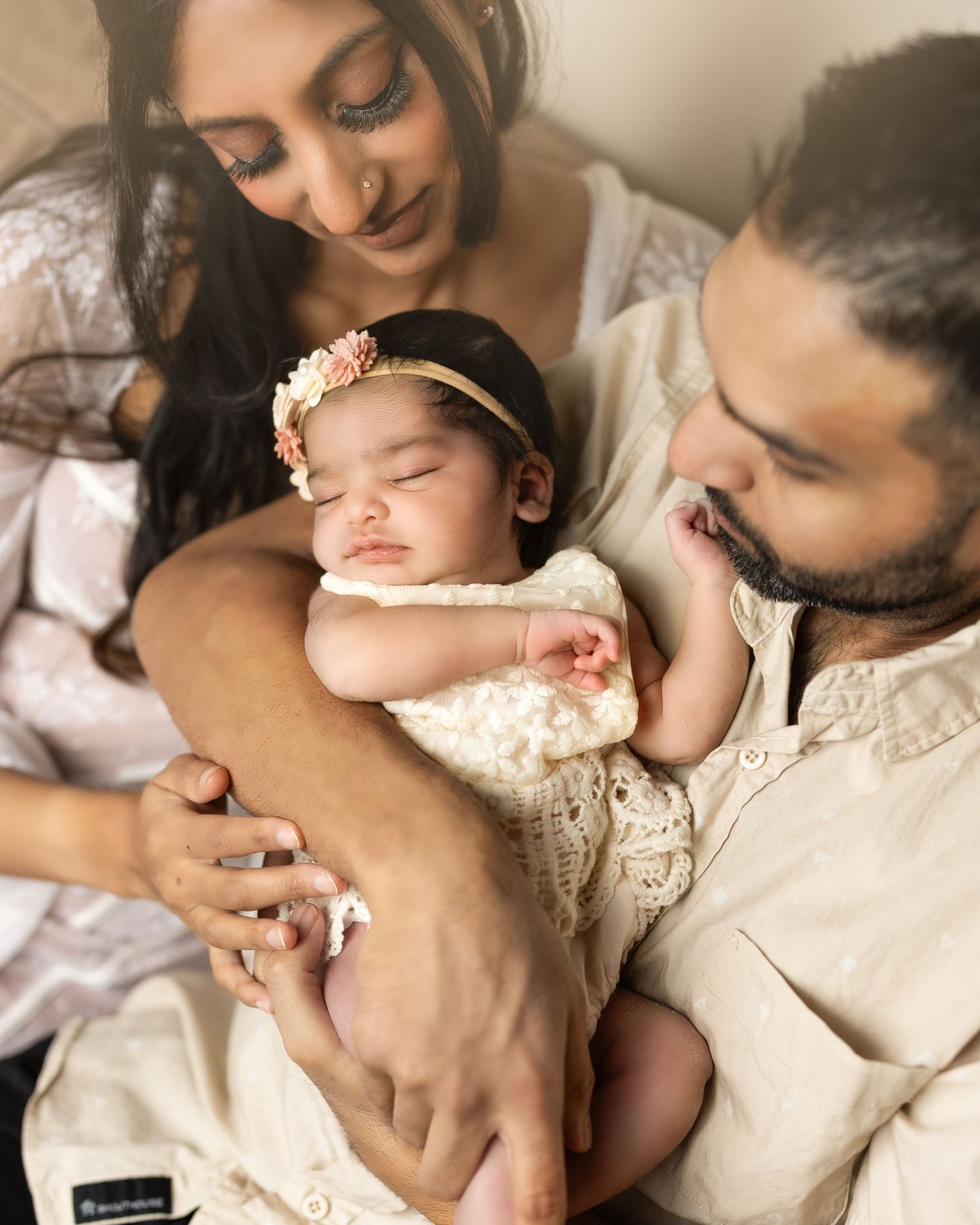 Parent and baby in matching cream outfits share tender moments in a series of intimate lifestyle portraits.