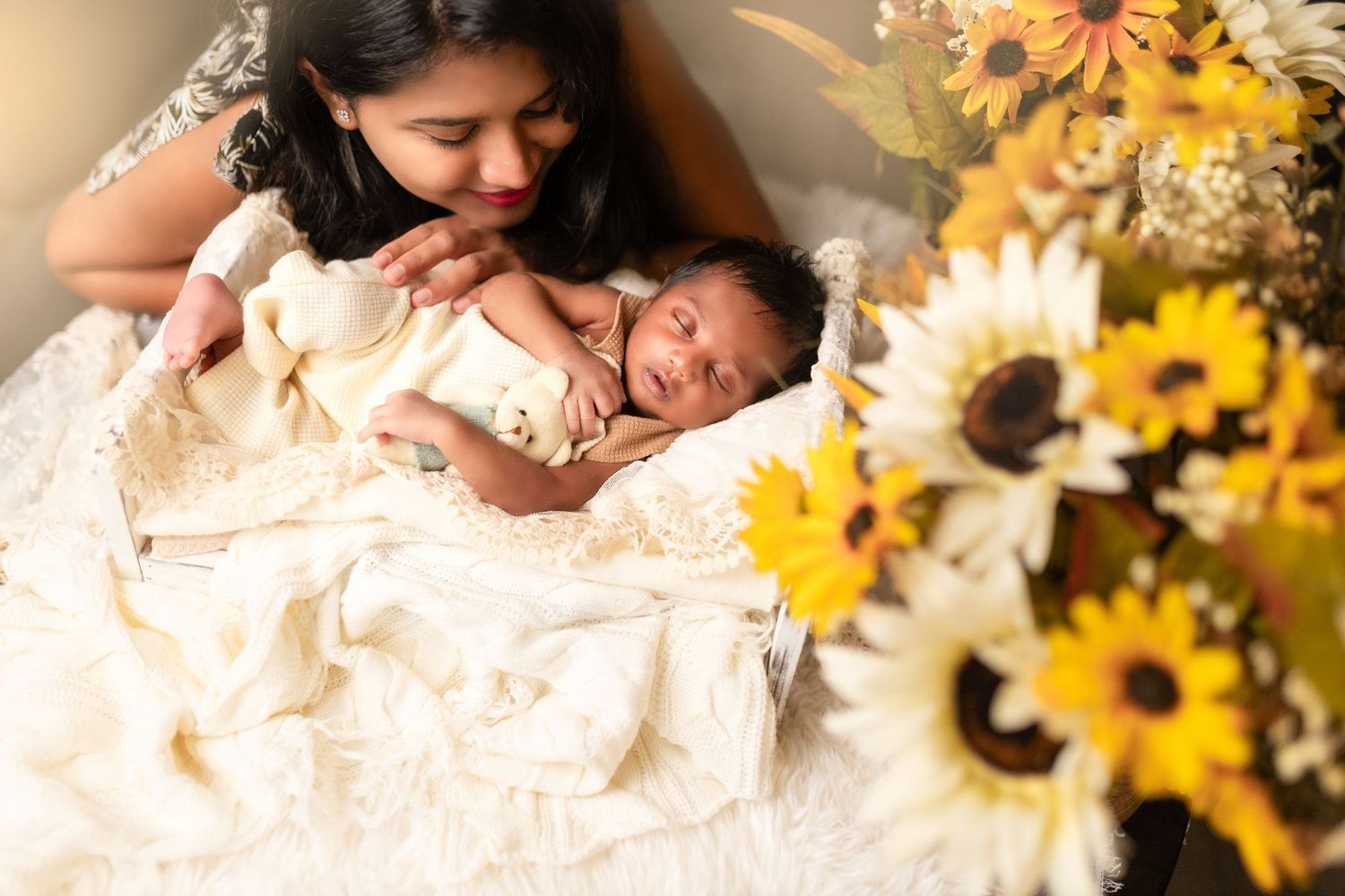 A romantic wedding photo session featuring sunflowers and a couple in white attire laying together.