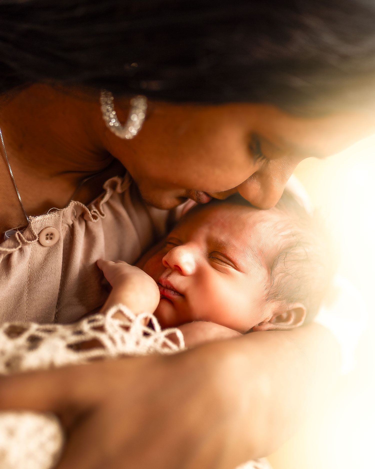 A close-up view of a sleeping baby in soft, warm lighting.
