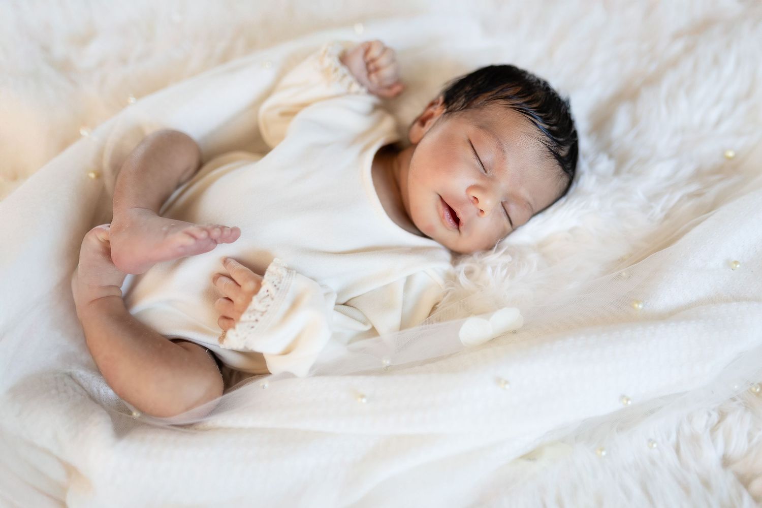 A peaceful scene of someone resting soundly in crisp white bedding.