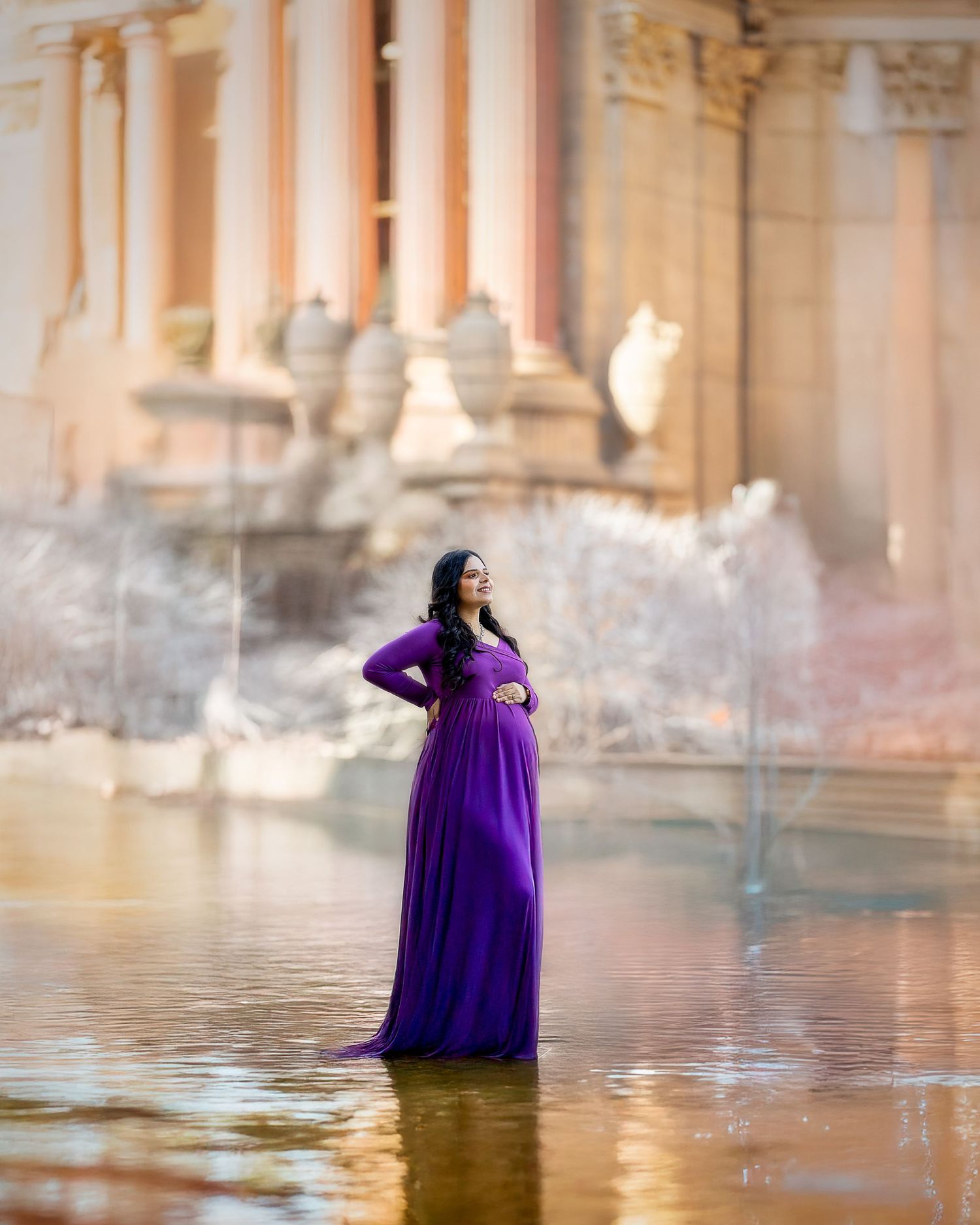 A series of ethereal photos showing a flowing purple gown in reflective water against classical architecture.