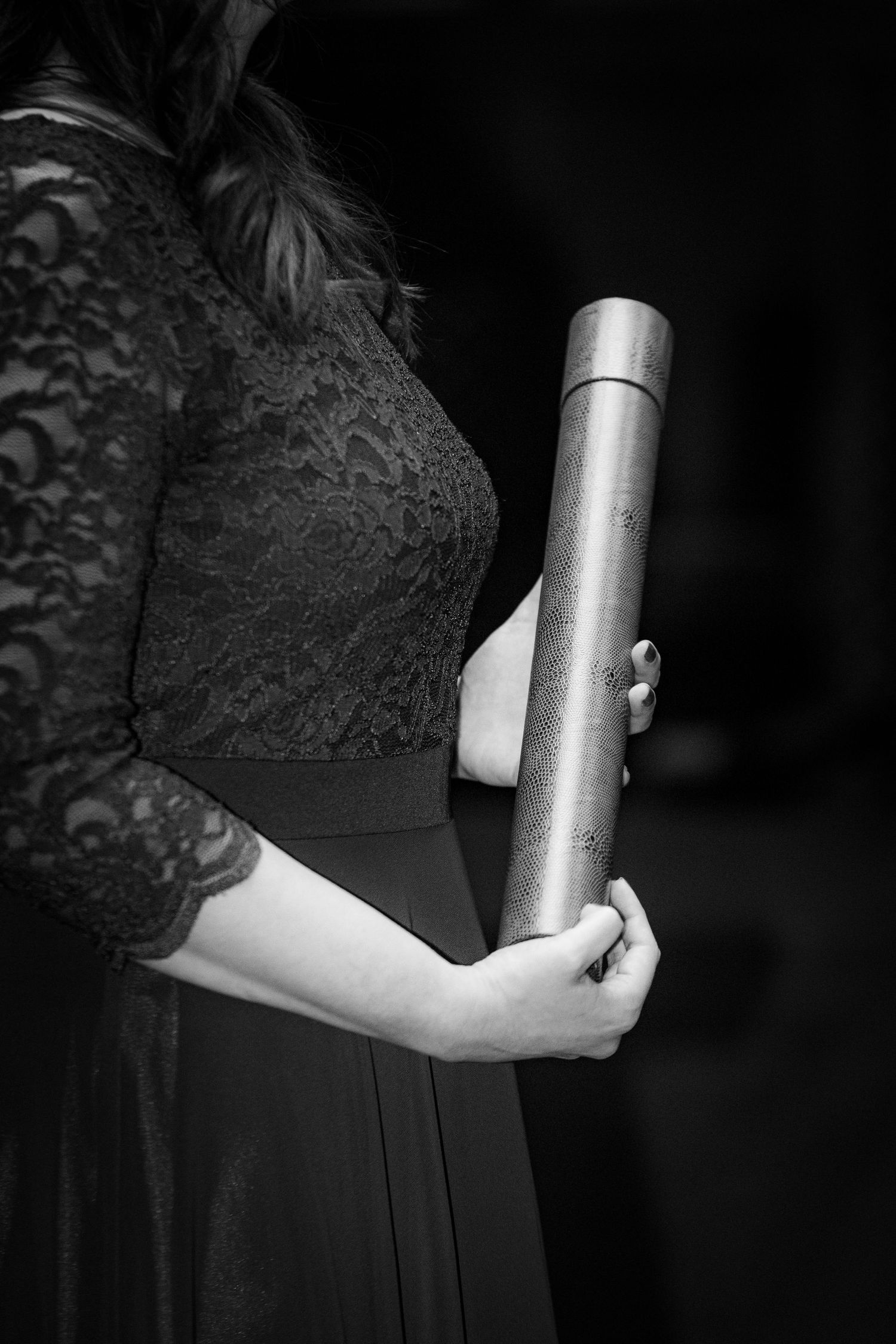 Close-up black and white detail shot of formal attire and accessories.