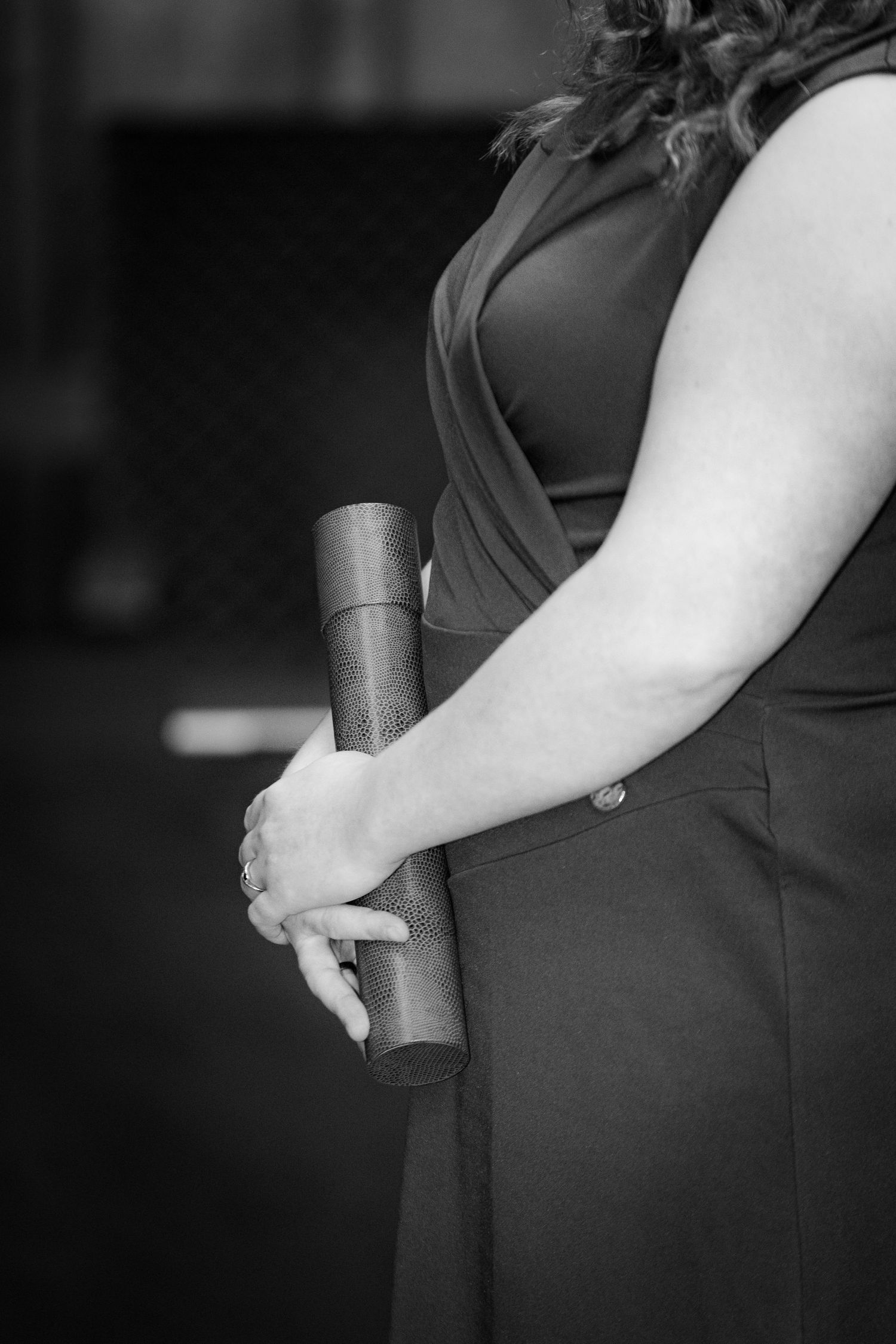 Close-up series of hands holding books in black and white.