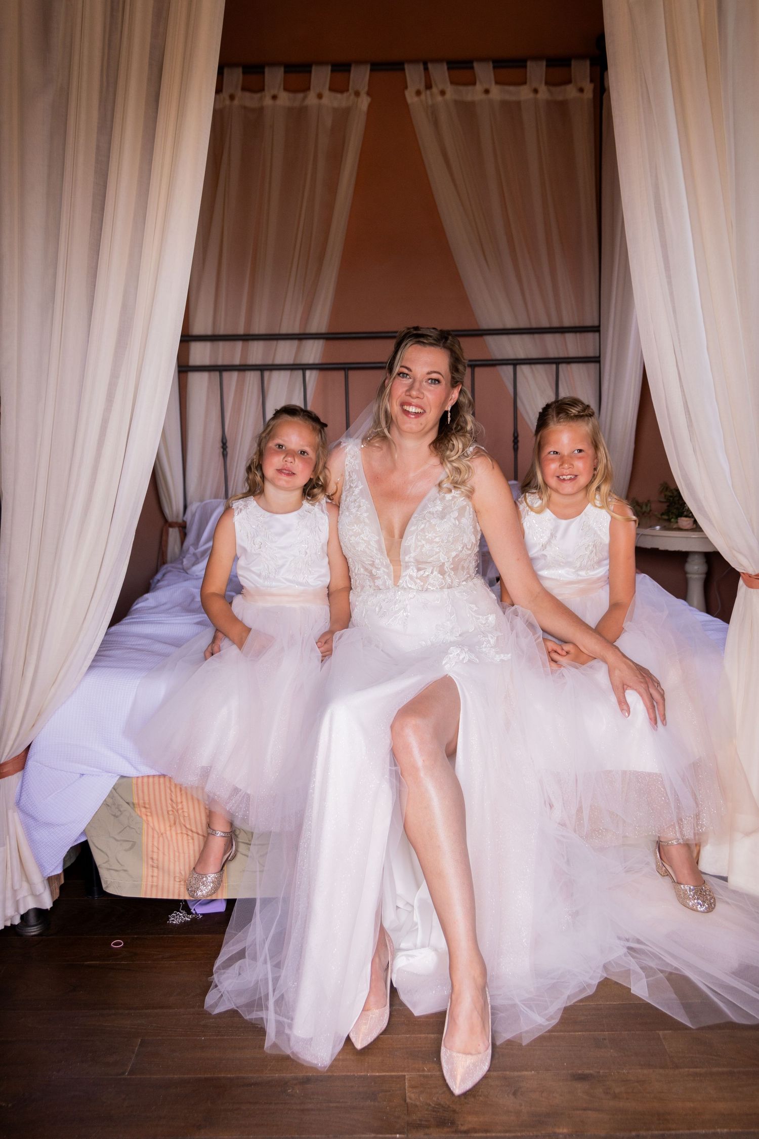 Five identical photos showing playful poses of bridesmaids in white dresses against flowing white curtains.