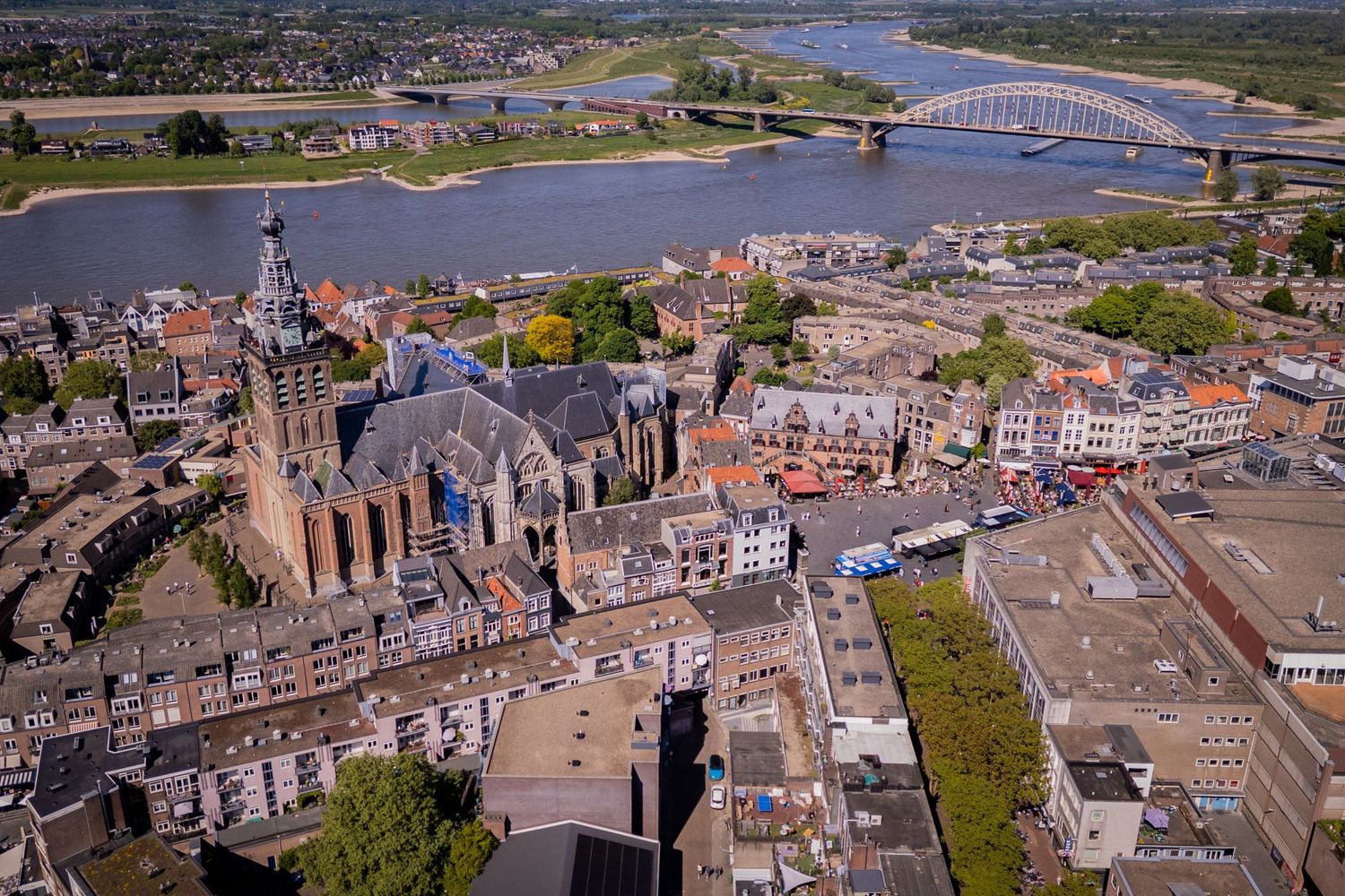 Panoramic aerial view of Nijmegen cityscape with historic buildings and Waal River bridges in the Netherlands.