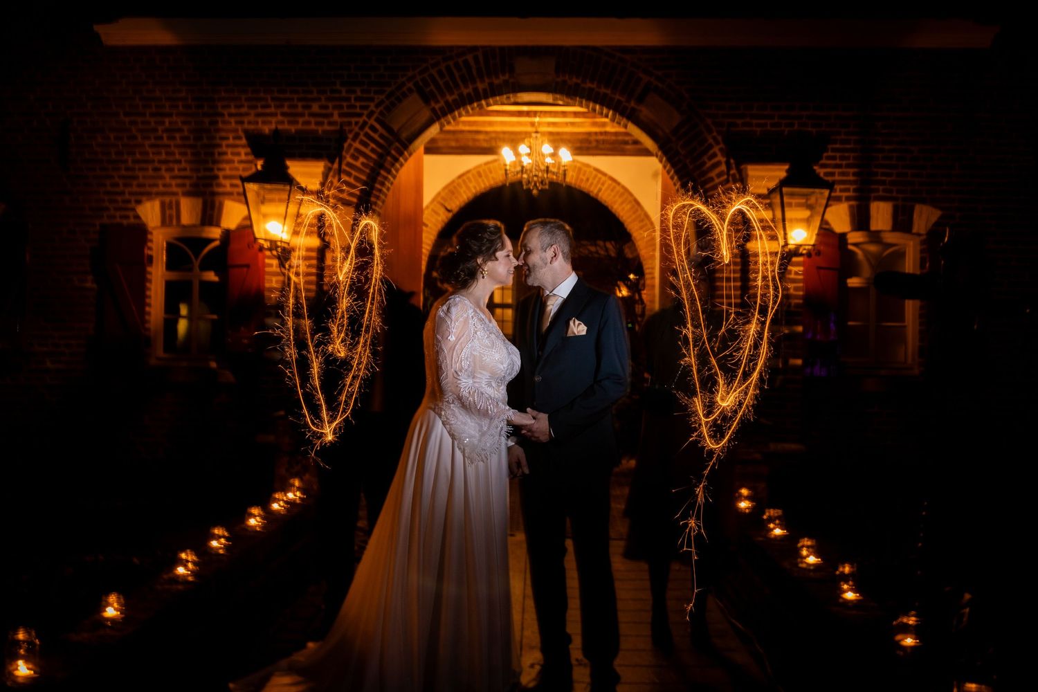 Romantic candlelit wedding venue with stone arches creating a dramatic atmosphere.