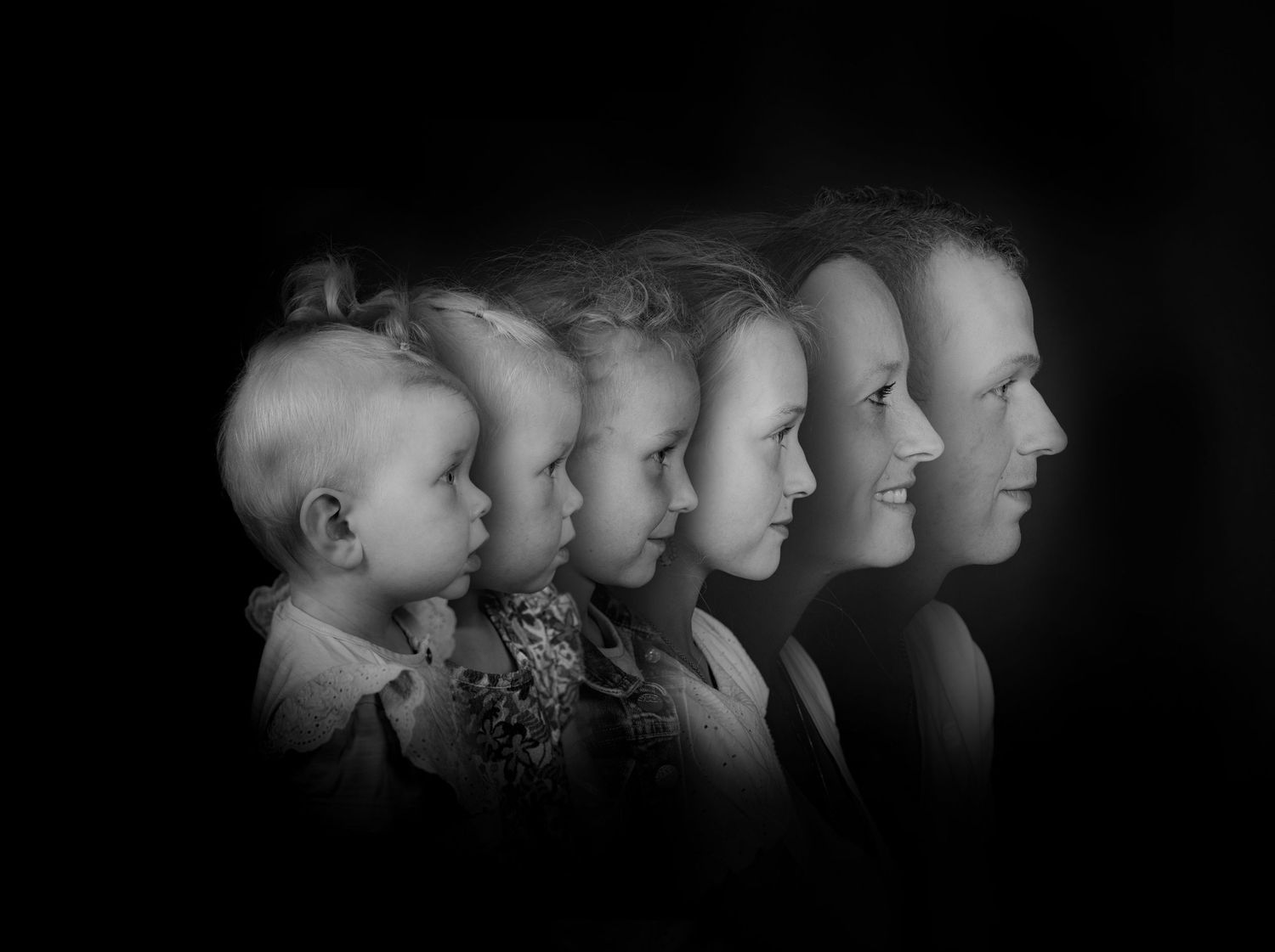 Artistic black and white portrait showing the aging progression from baby to adult in profile views.