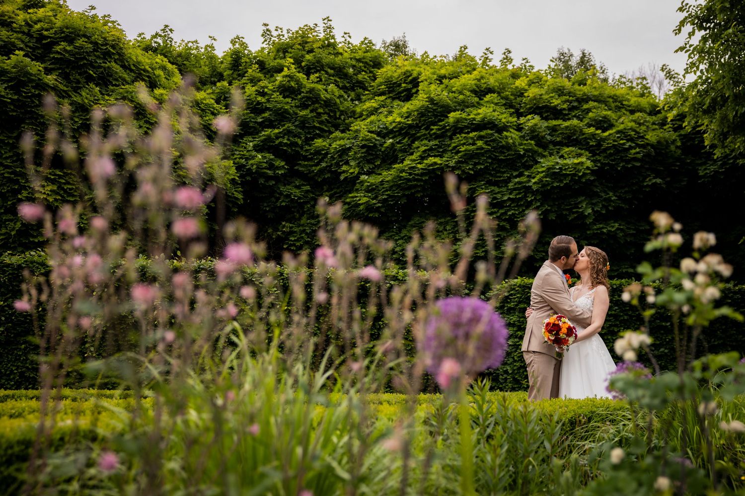A romantic garden scene with wildflowers and greenery framing the moment.