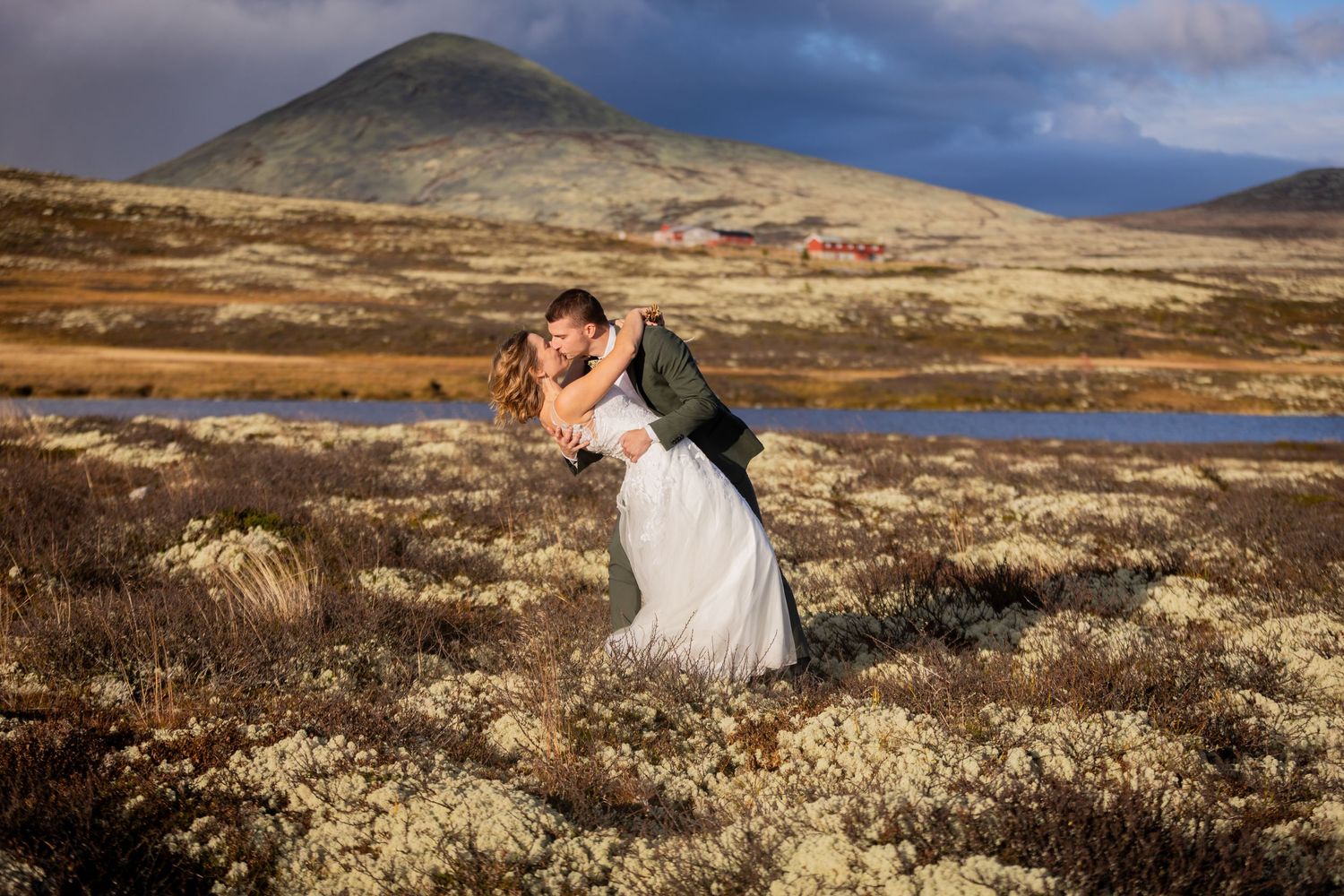 A dramatic mountain landscape wedding portrait with rolling hills and moody skies.