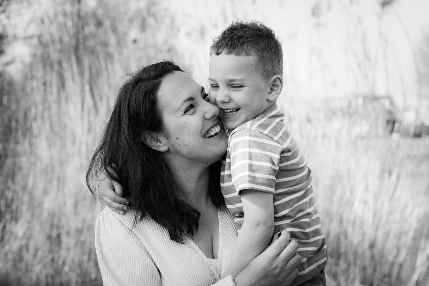 A tender black and white portrait showing a moment of joy and connection.