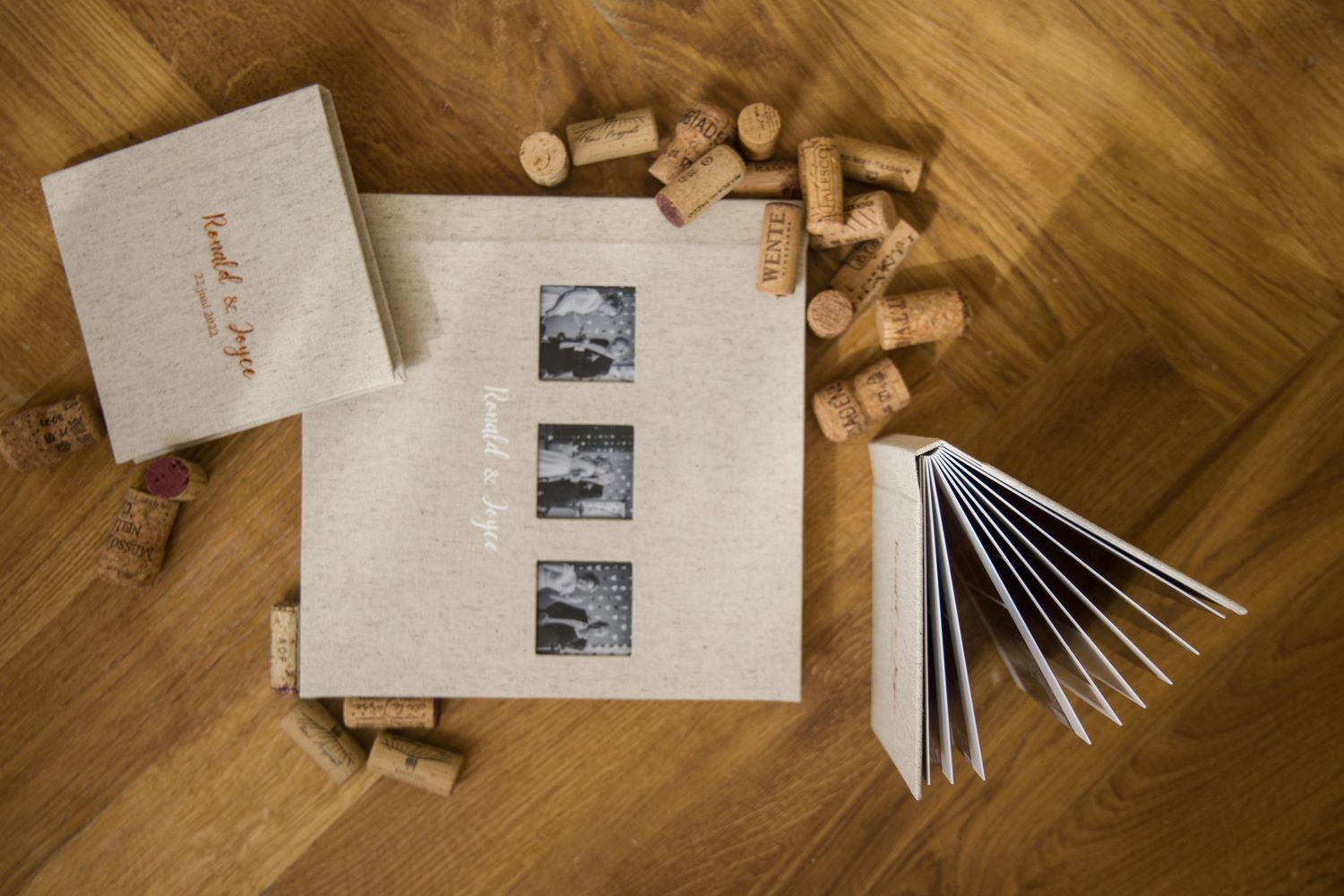Elegant white stationery set with wooden accents arranged on brown wooden background from various angles.