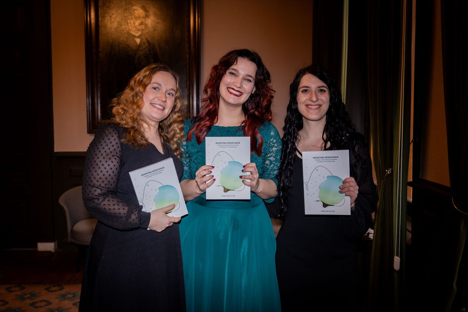 Group celebrating with certificates in an elegant indoor setting.