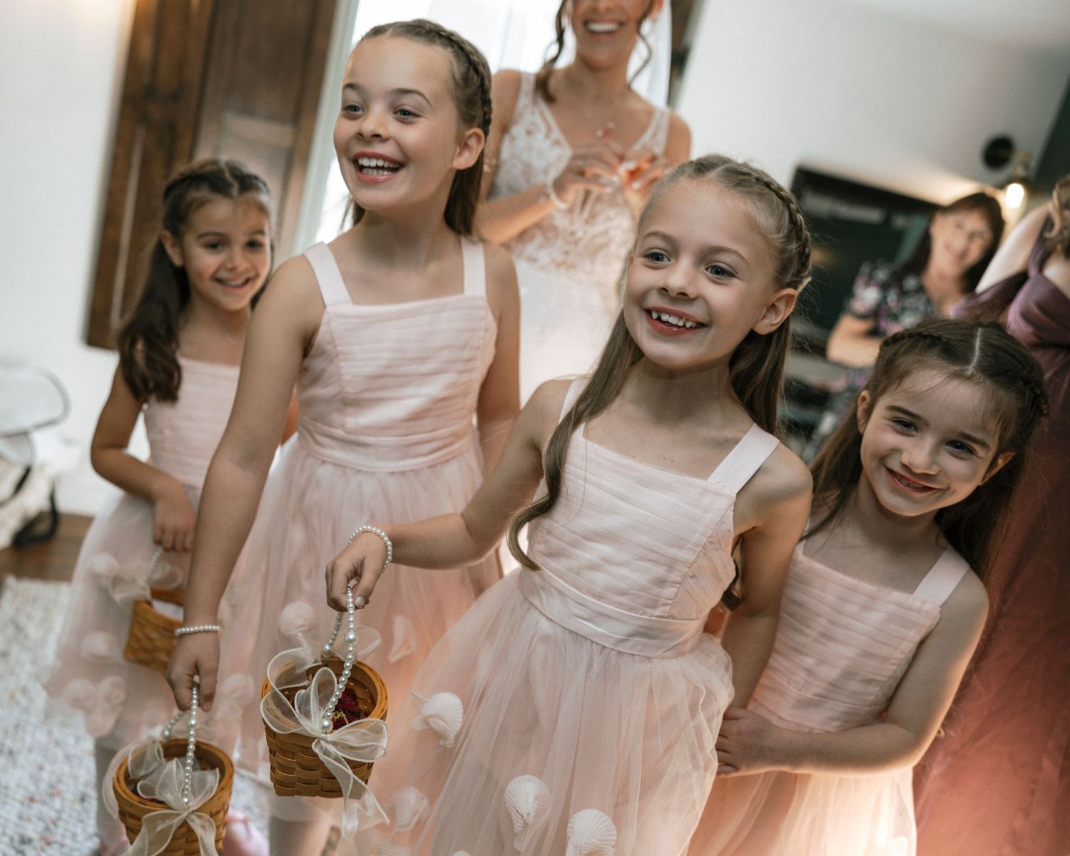 Young dancers in pink tutus and leotards lined up in a hallway backstage.
