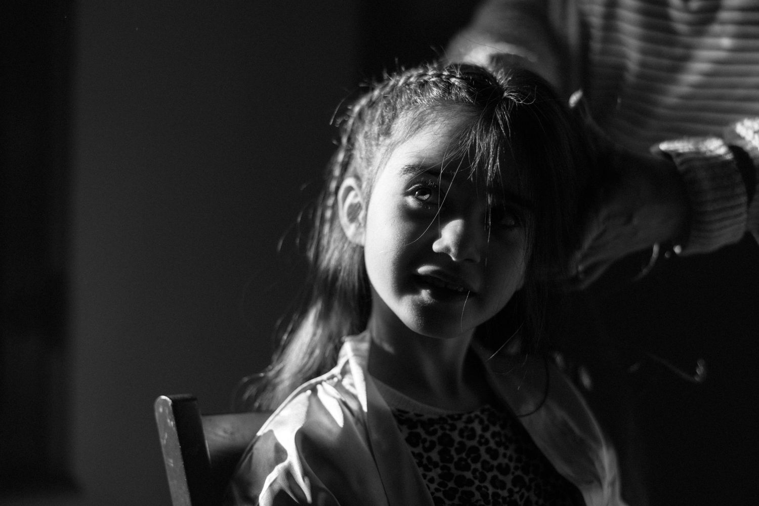 Dramatic black and white portrait showing light and shadow effects.