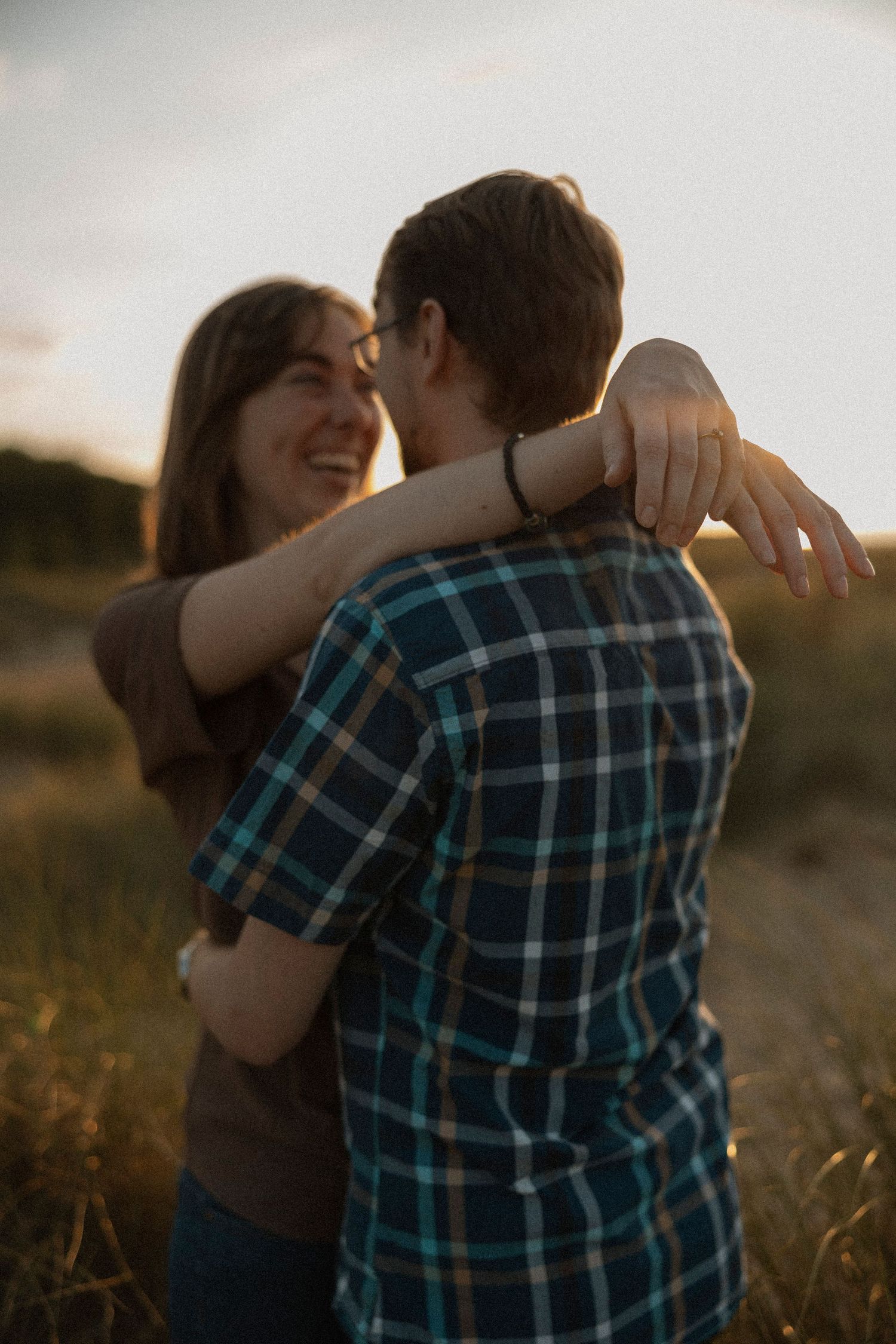 Intimate embrace captured during golden hour outdoor photoshoot.