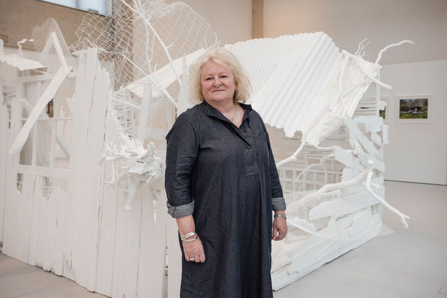 Artist in front of exhibit.