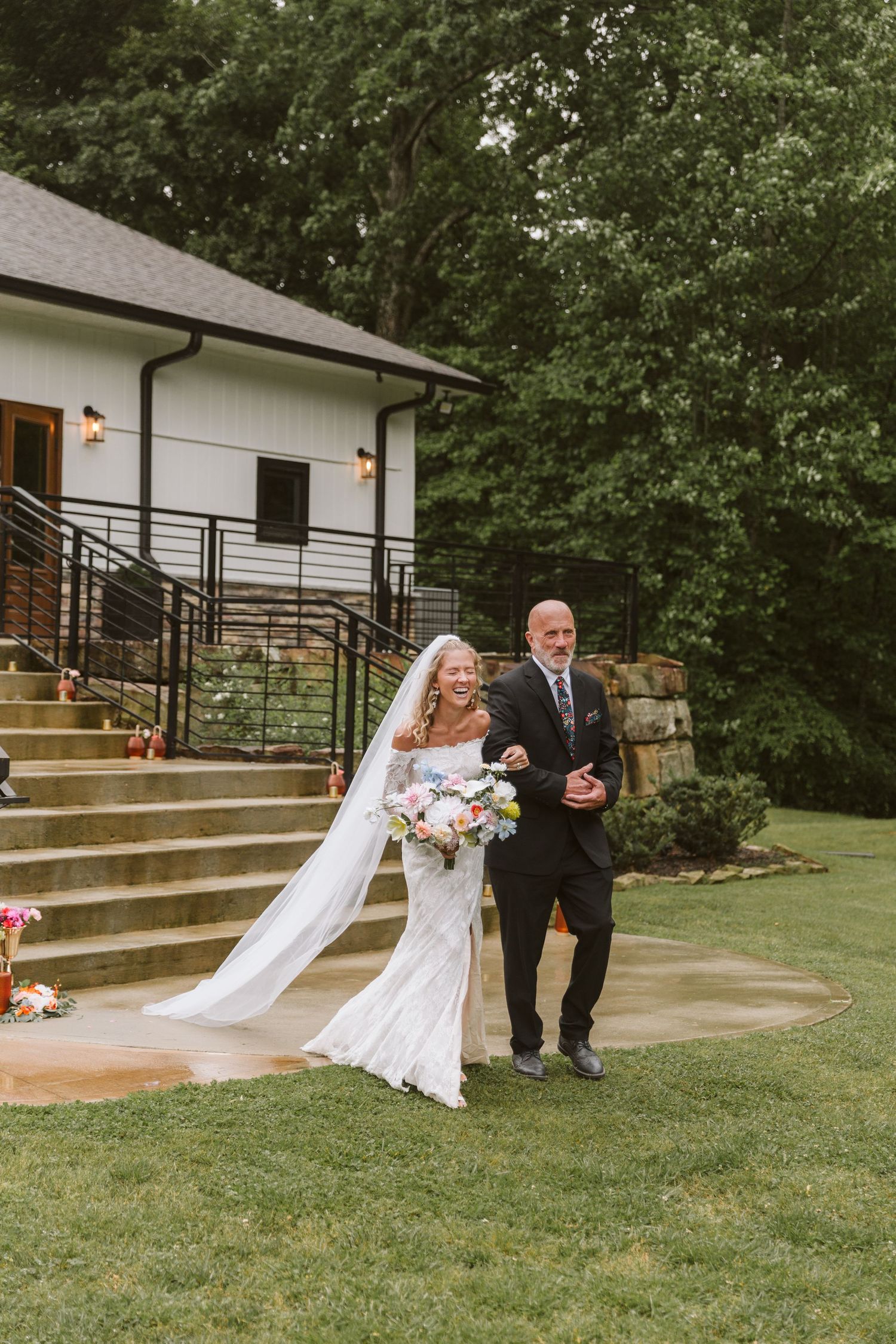 Father of the Bride walking daughter down stairs to the wedding aisle
