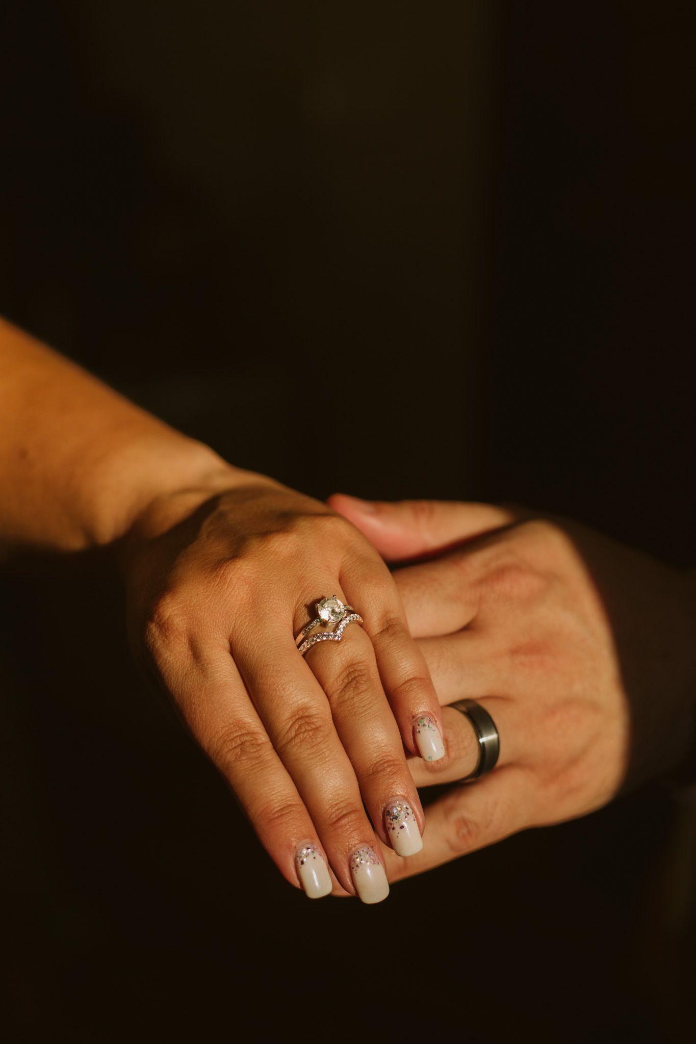 Couples hands holding the other showing off their wedding rings