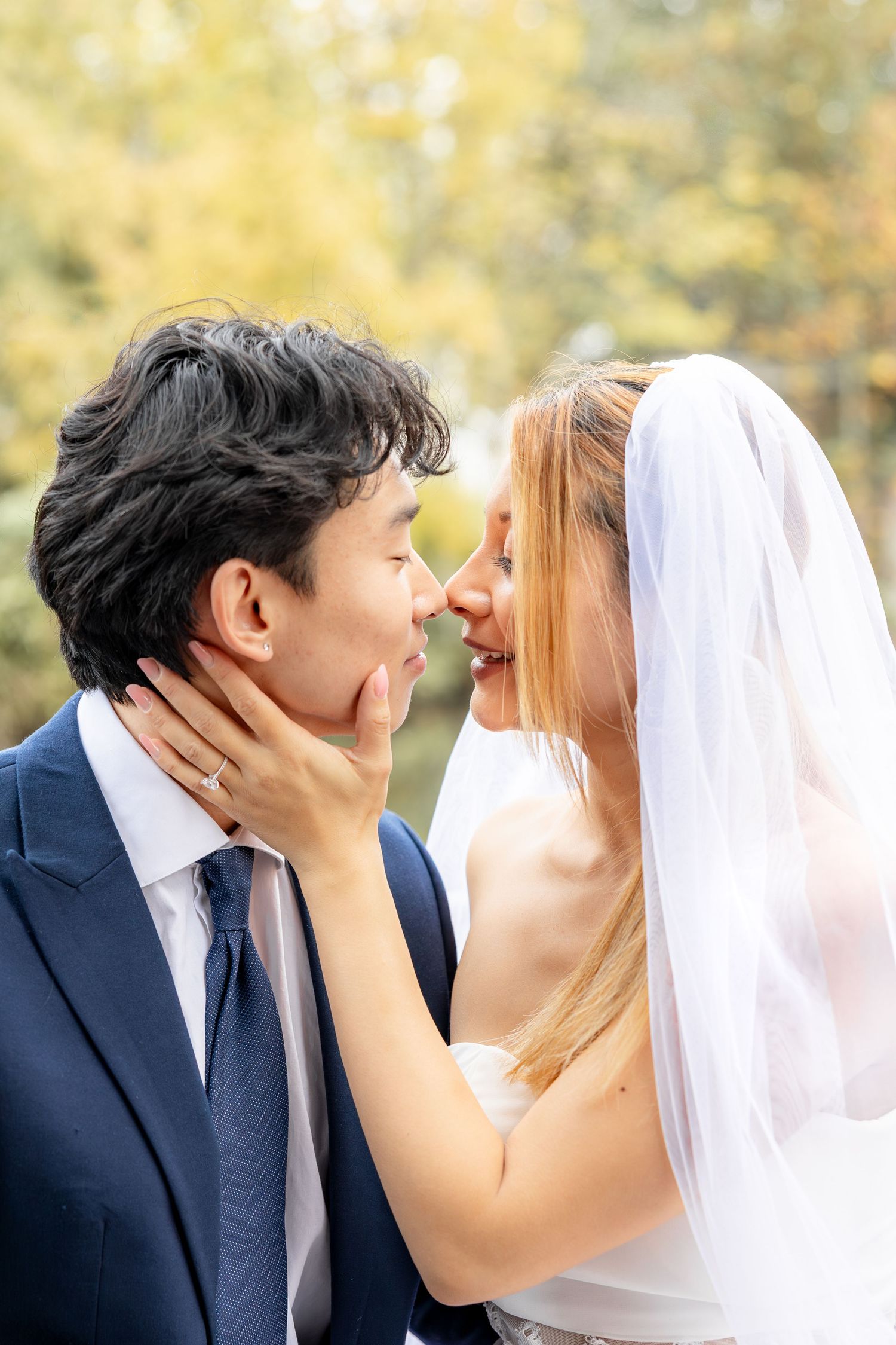 Intimate wedding portraits captured outdoors with soft natural lighting.