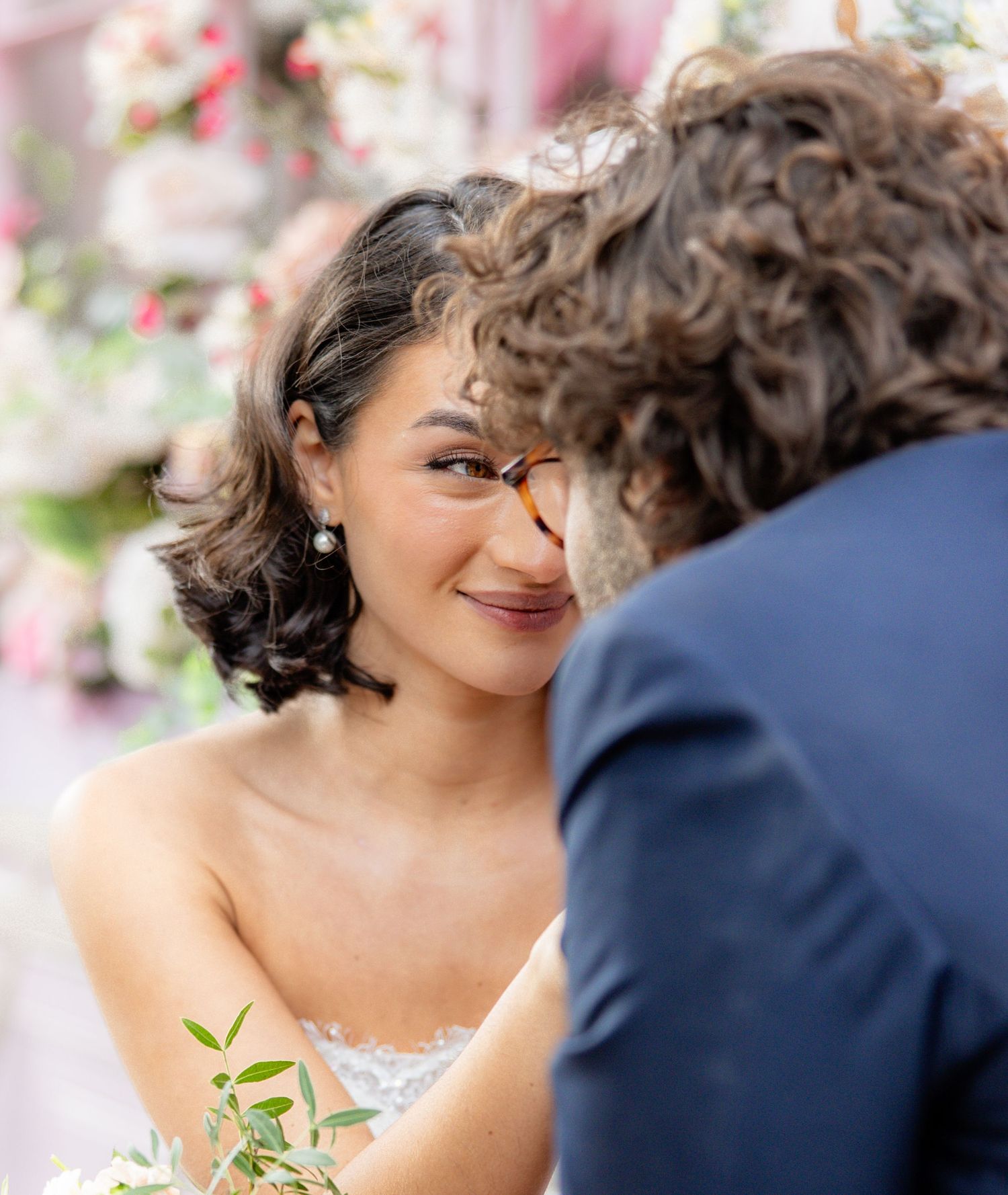 Romantic close-up wedding portraits with soft lighting and floral details.