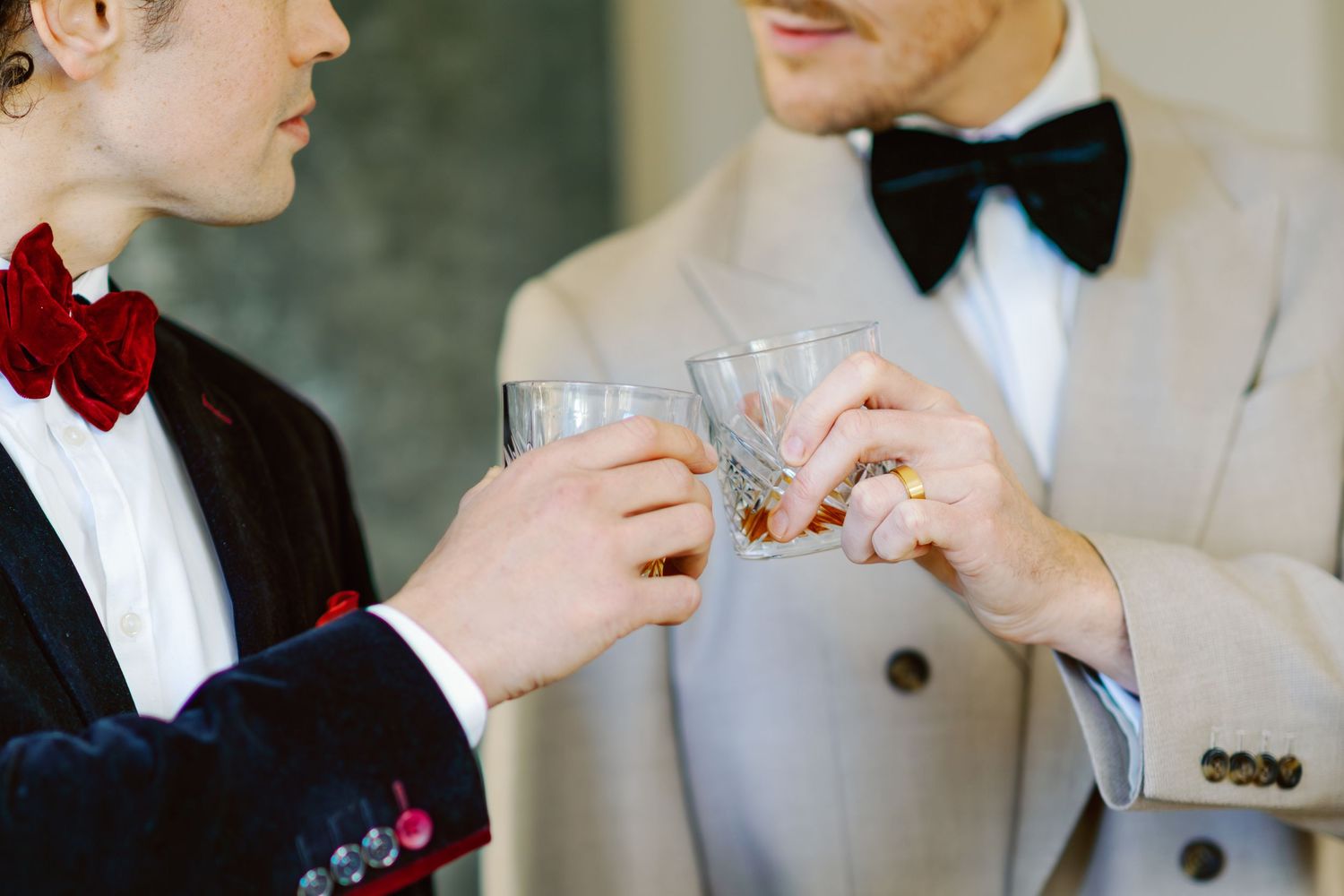 Wedding party members toast with champagne glasses in formal attire.