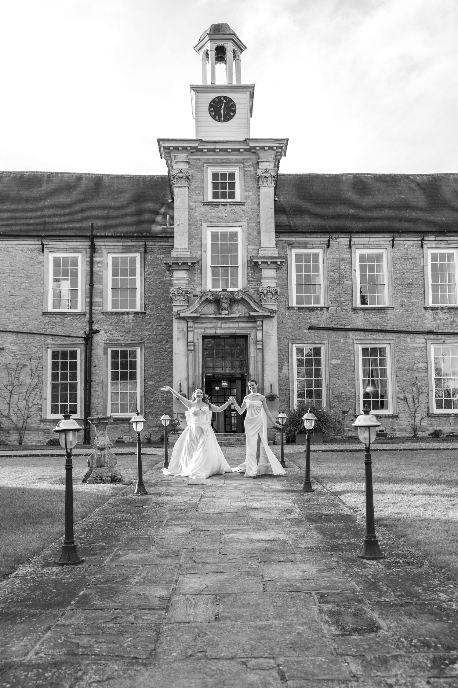 Black and white photo of a historic building exterior with elegant stone facade and clock tower.