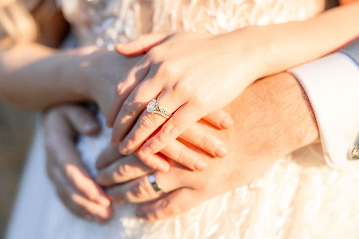 Close up of hands with wedding rings in natural light.