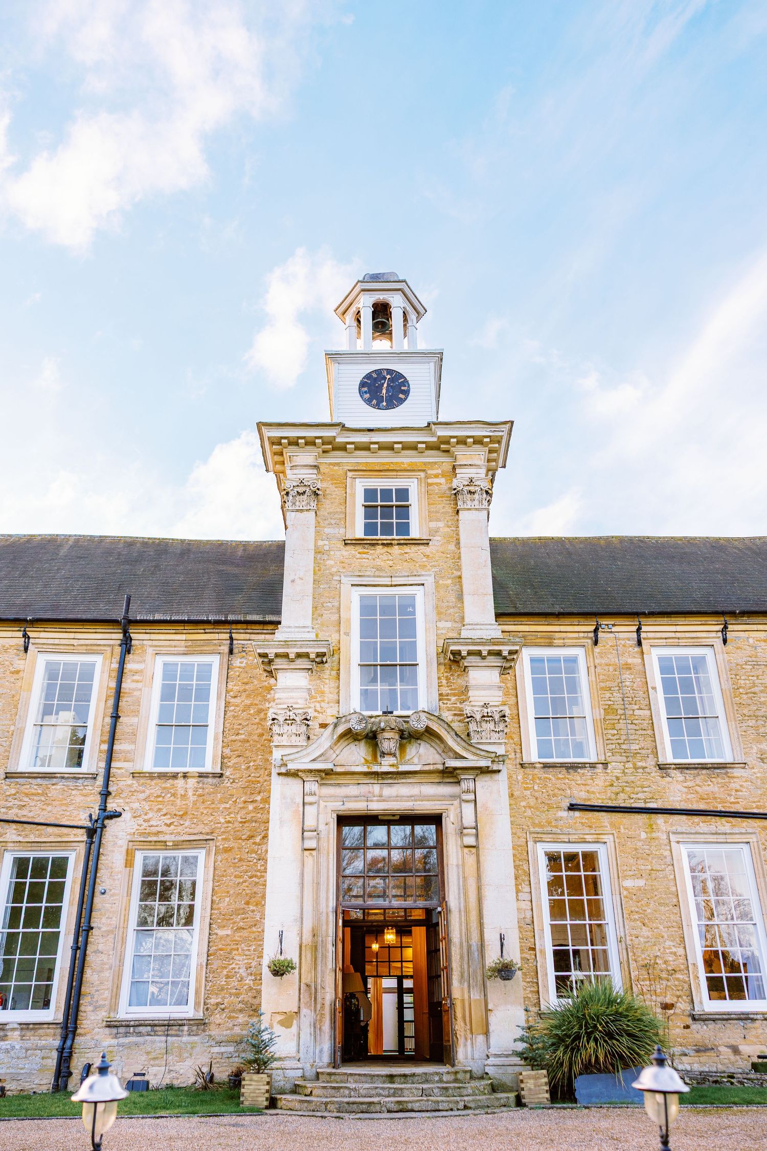 Historic stone building facade with clock tower and Georgian-style windows showcases traditional British architecture.