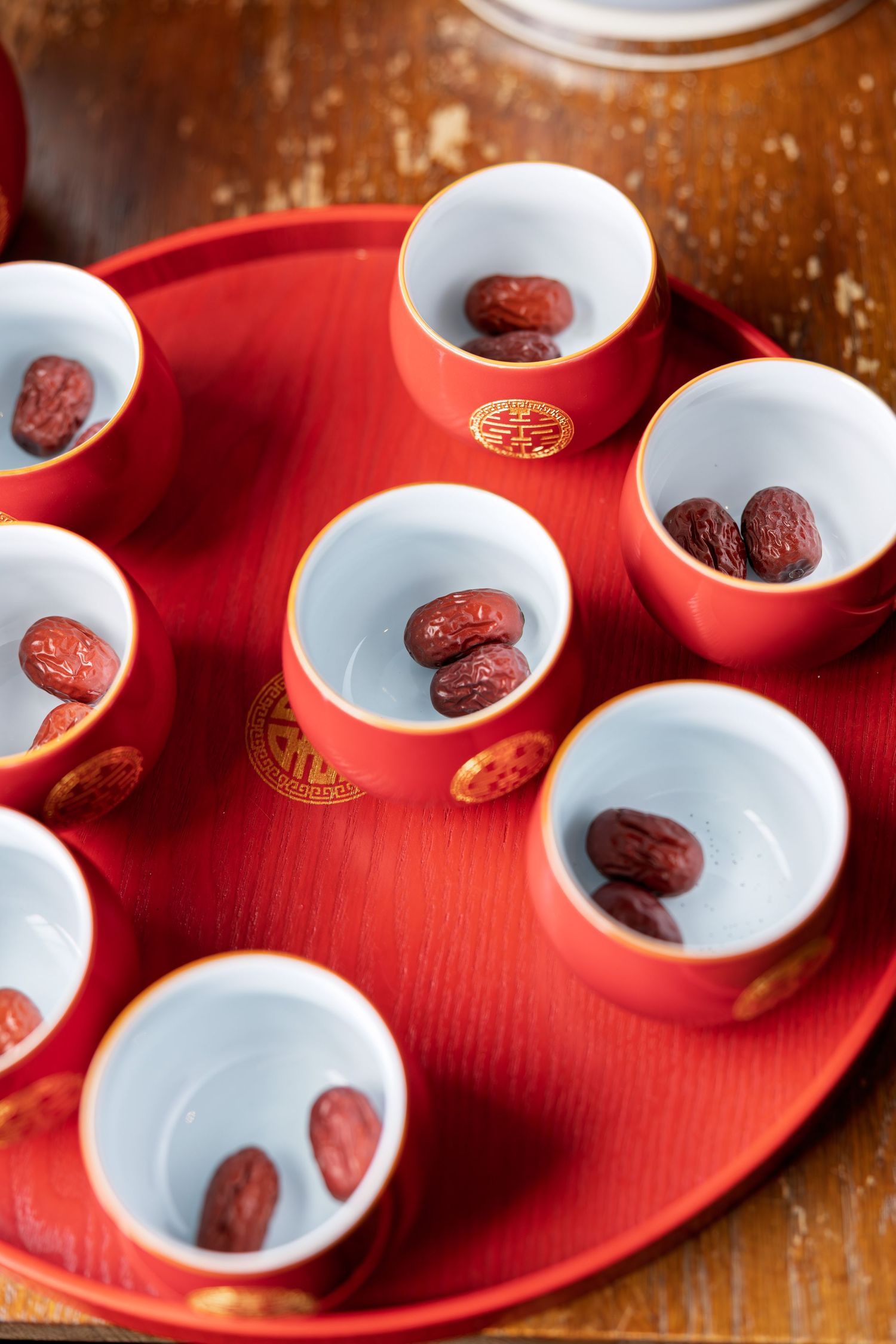 Red Chinese wedding tea ceremony cups on tray with red dates, featuring double happiness symbols.
