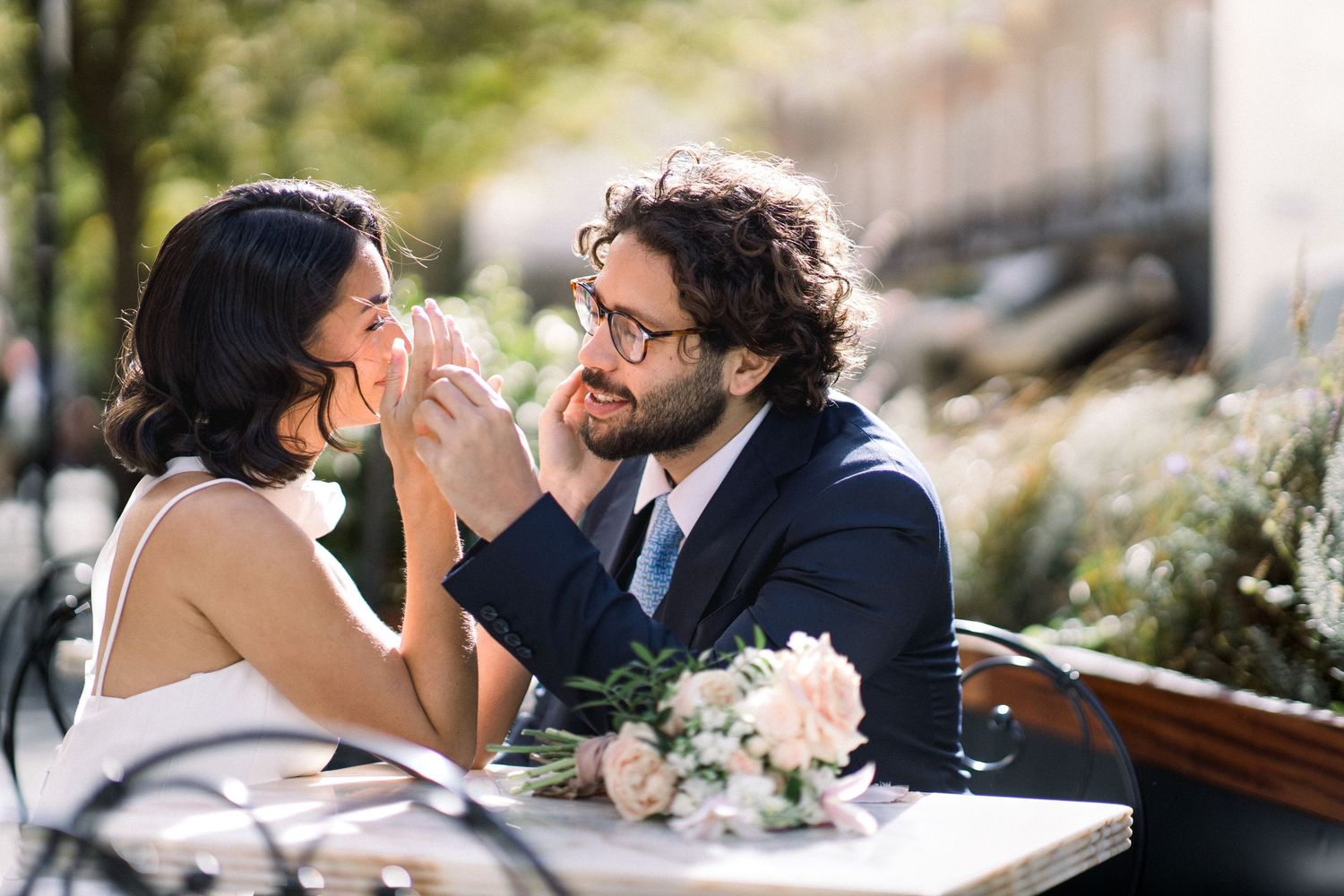 A couple in wedding attire share intimate moments in a series of romantic outdoor photos.