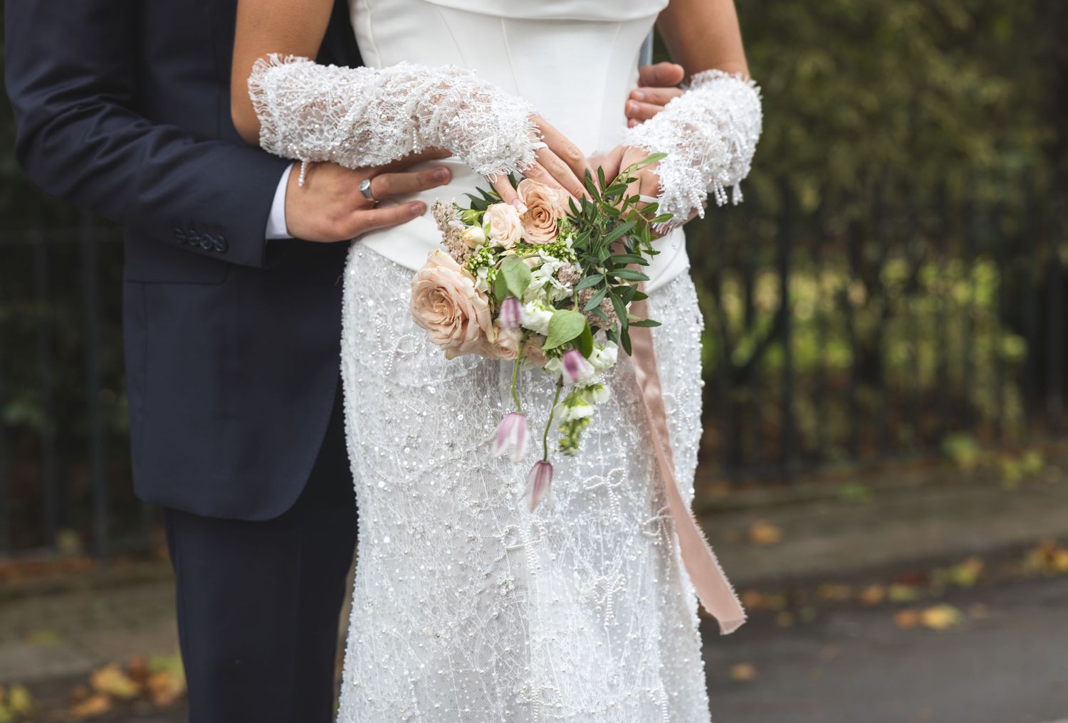 Close-up of delicate lace details on a white wedding dress.