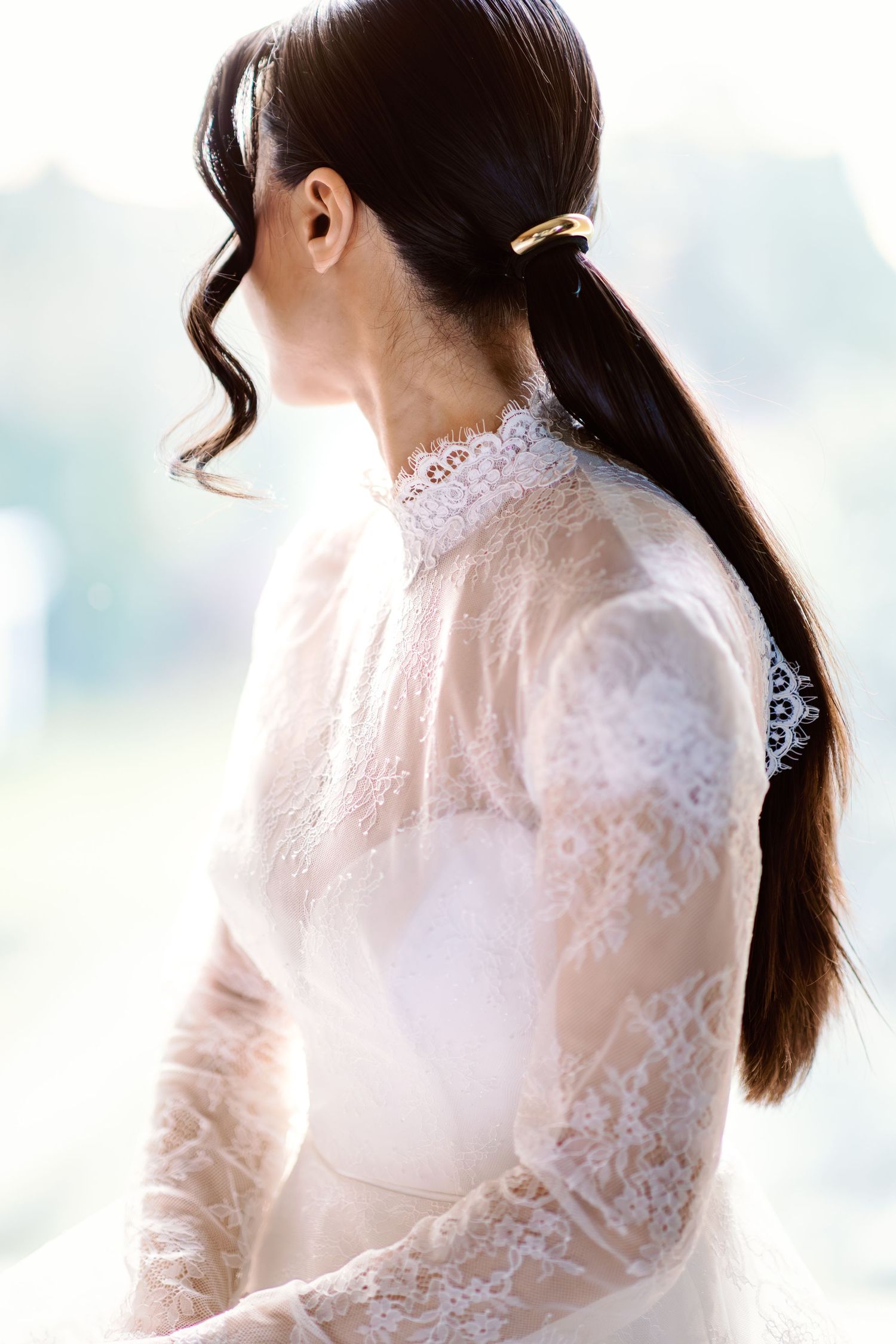 Elegant bridal portraits showcasing high neck lace details in natural window light.