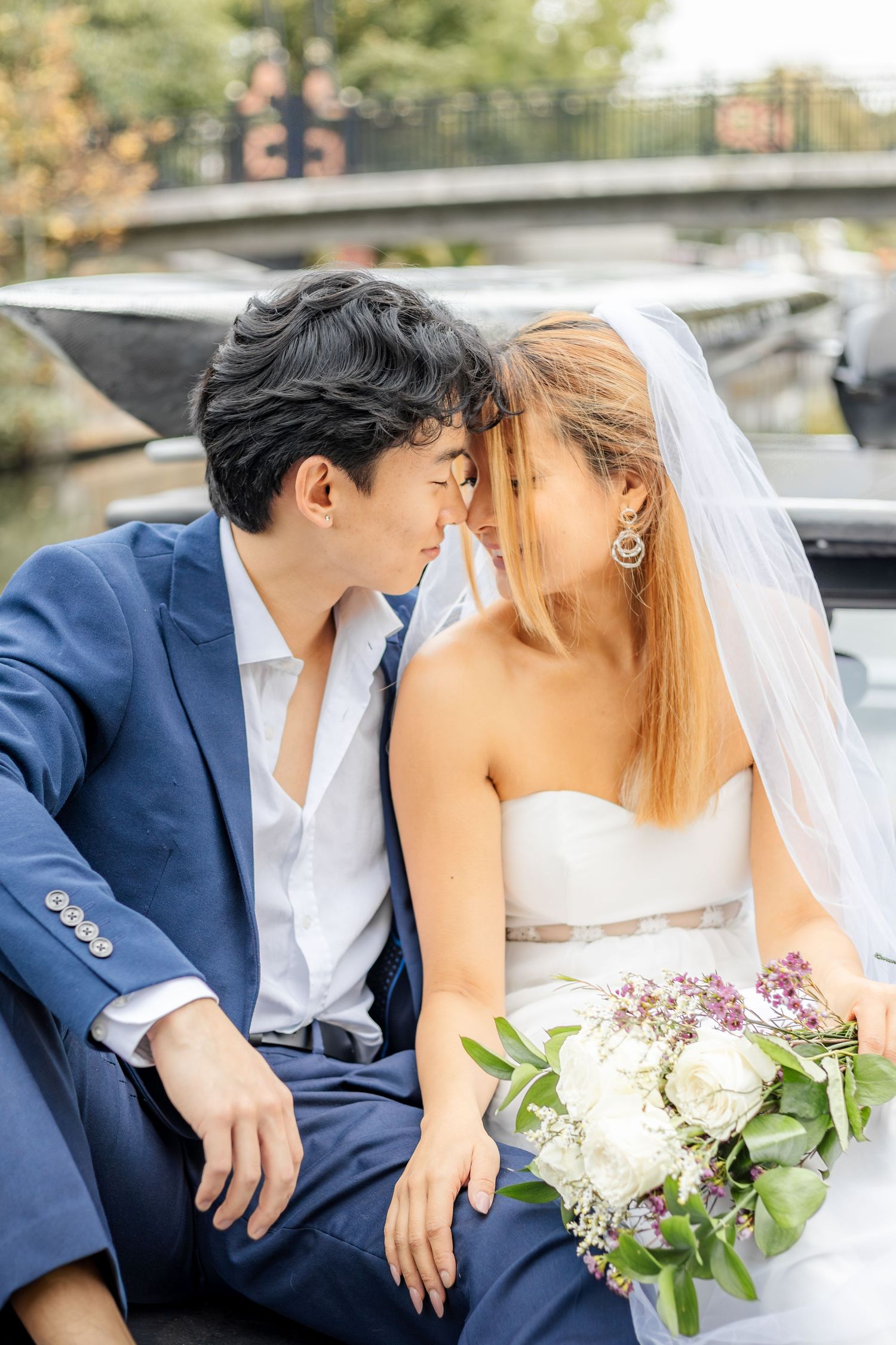 Intimate wedding portraits captured on classic car with autumn scenery.