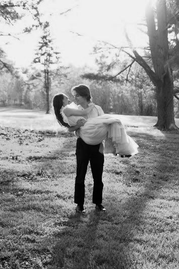 He picks up his fiance in a graceful pose.