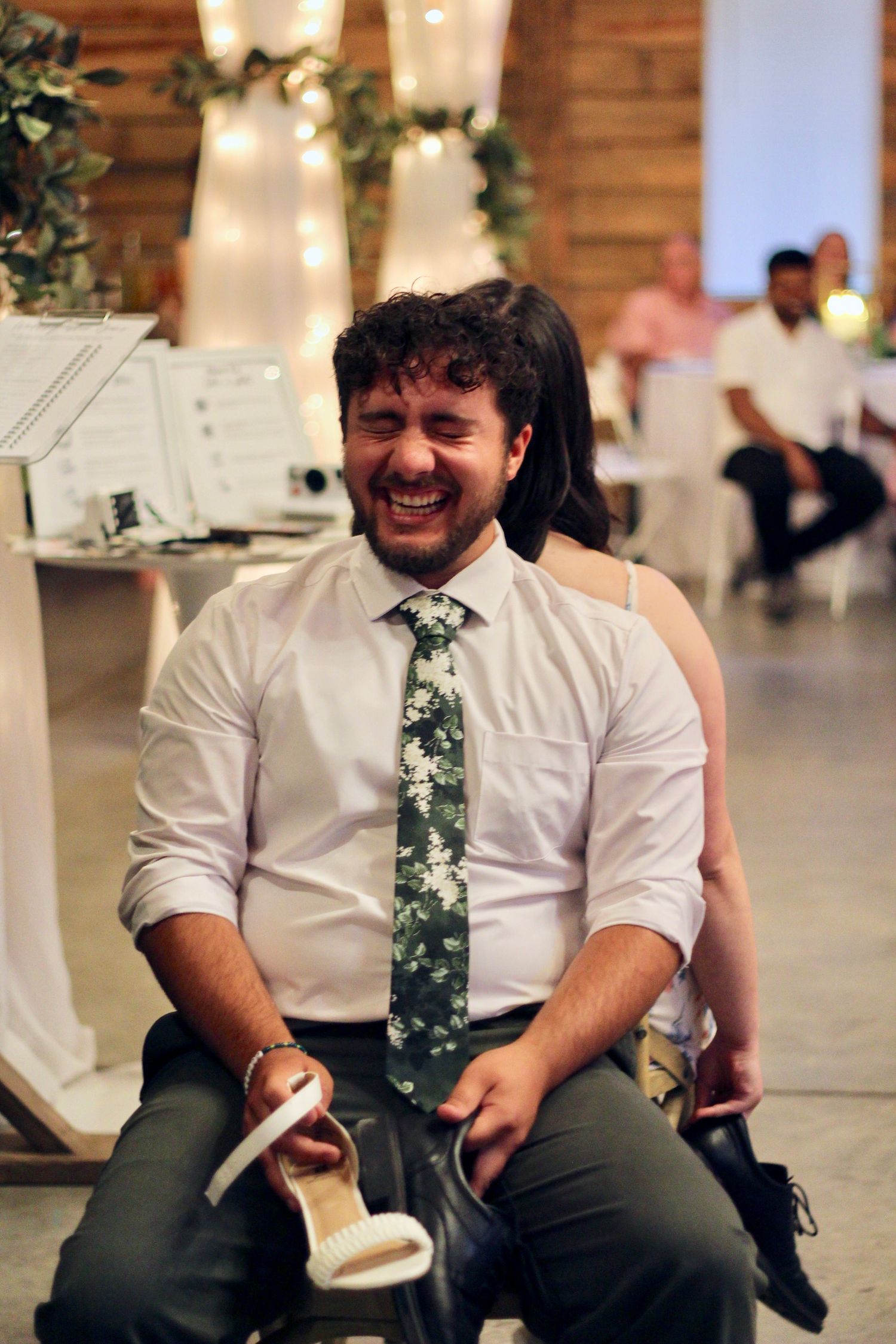 Groom laughing during the shoe game.