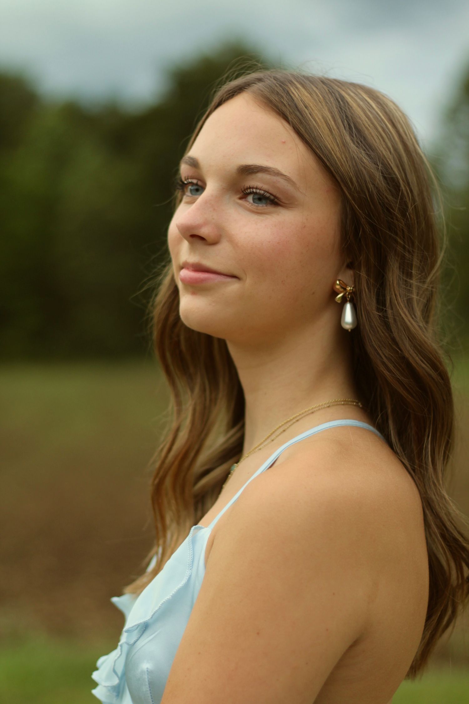 A close up shot of her earring, as she looks into the distance.