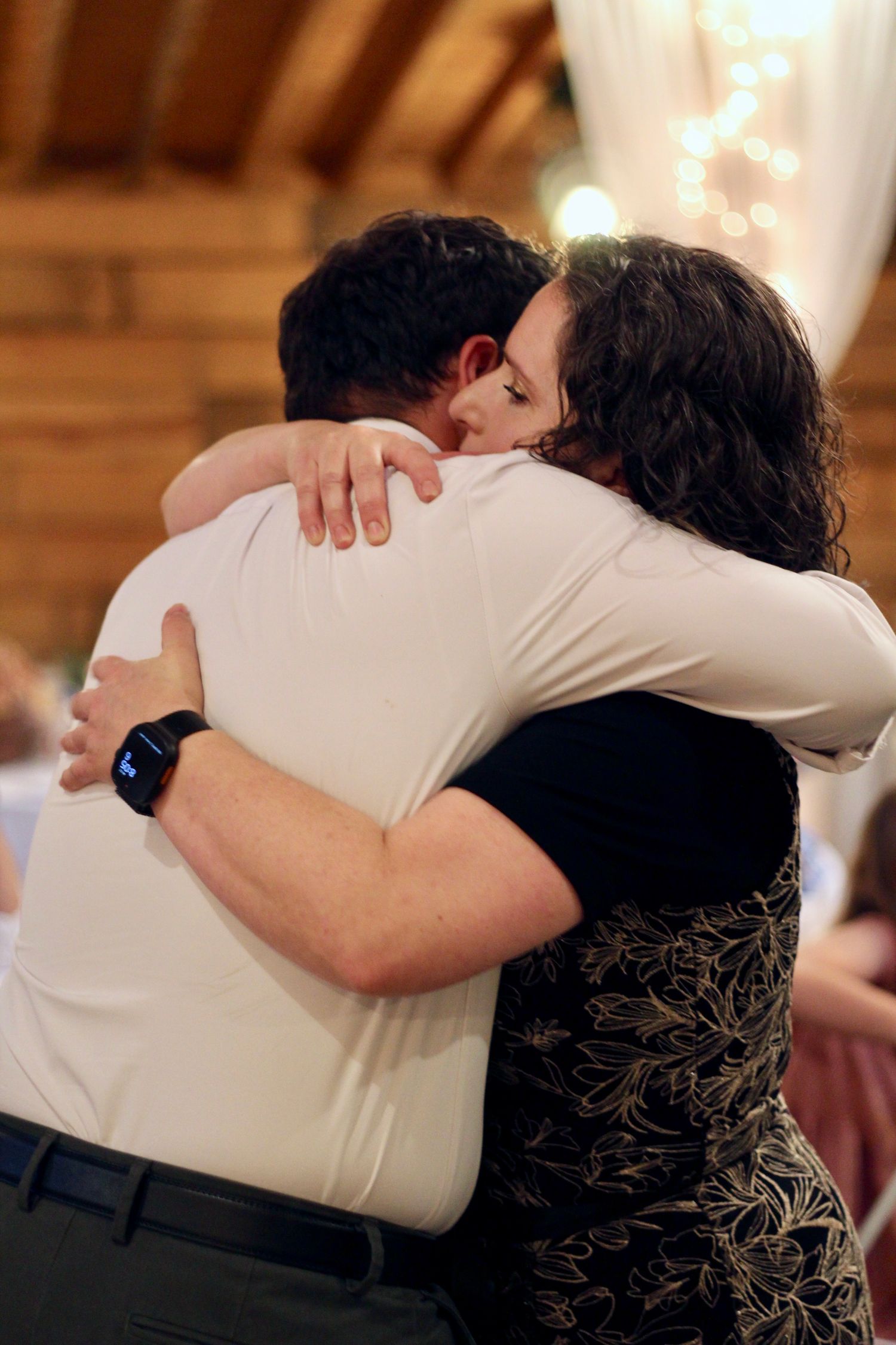 Mom hugging her son.