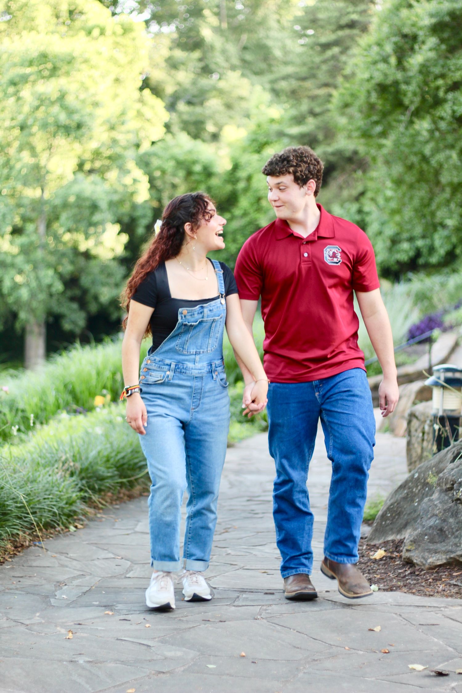 A couple walking through Falls Park.