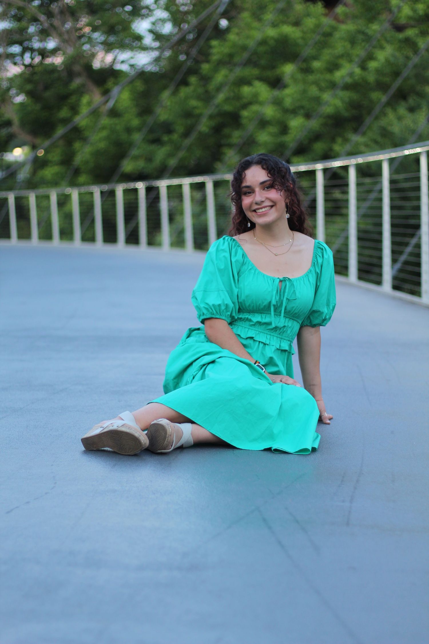 She's seated on the Liberty Bridge in Downtown Greenville.
