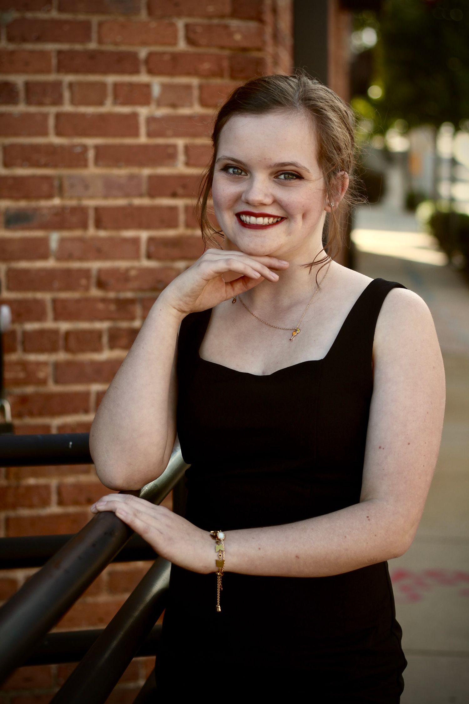 Her perfect smile, complete with the brick background makes this a superb photograph.