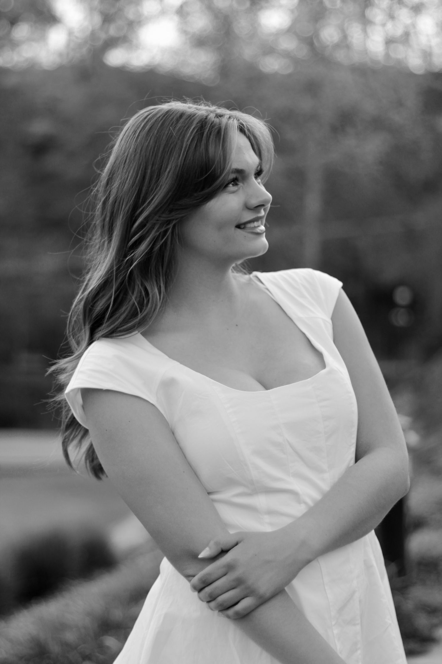 She's looking into the distance in her white gown.