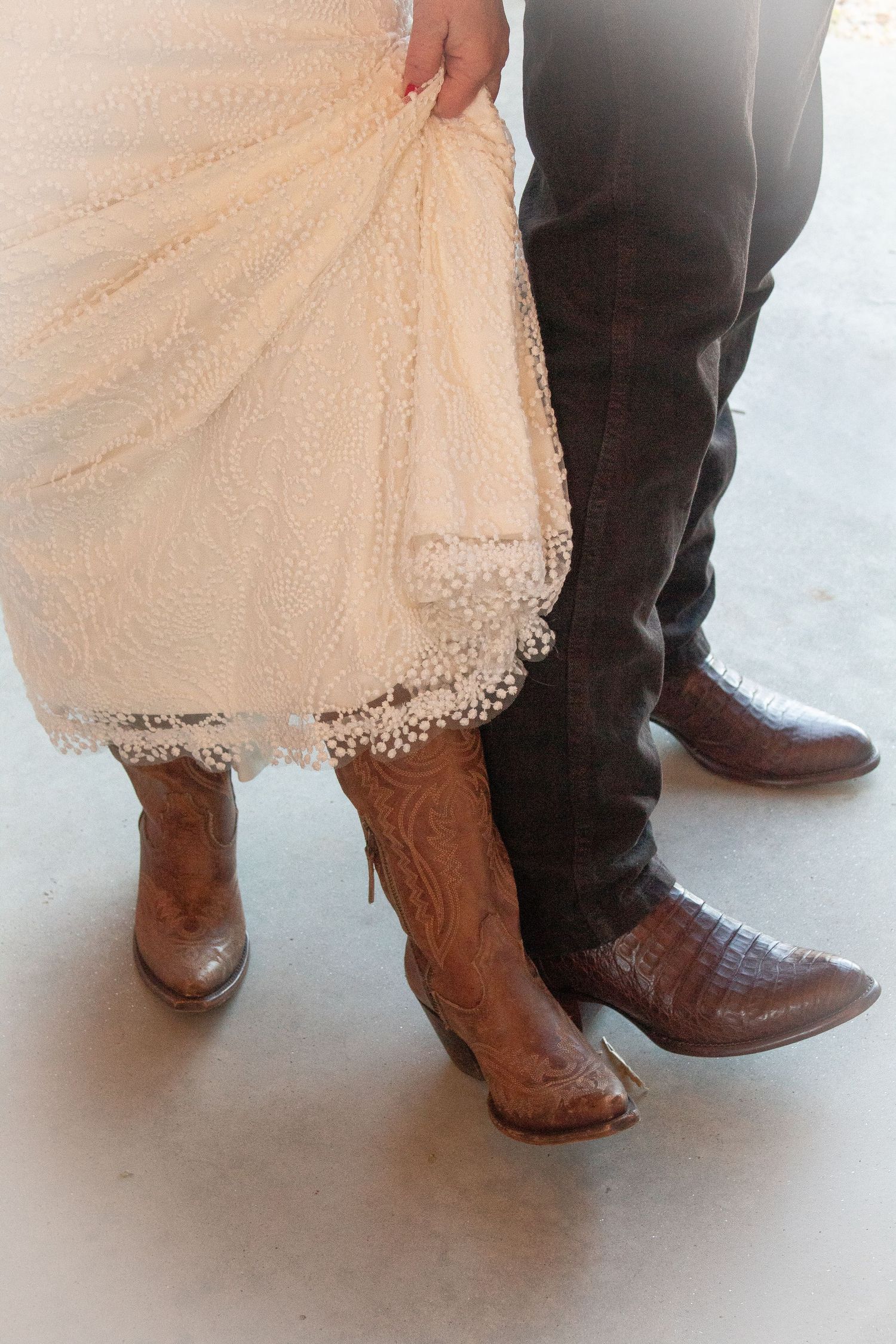 Showing off the cute boots: bride & groom matched for the wedding day.